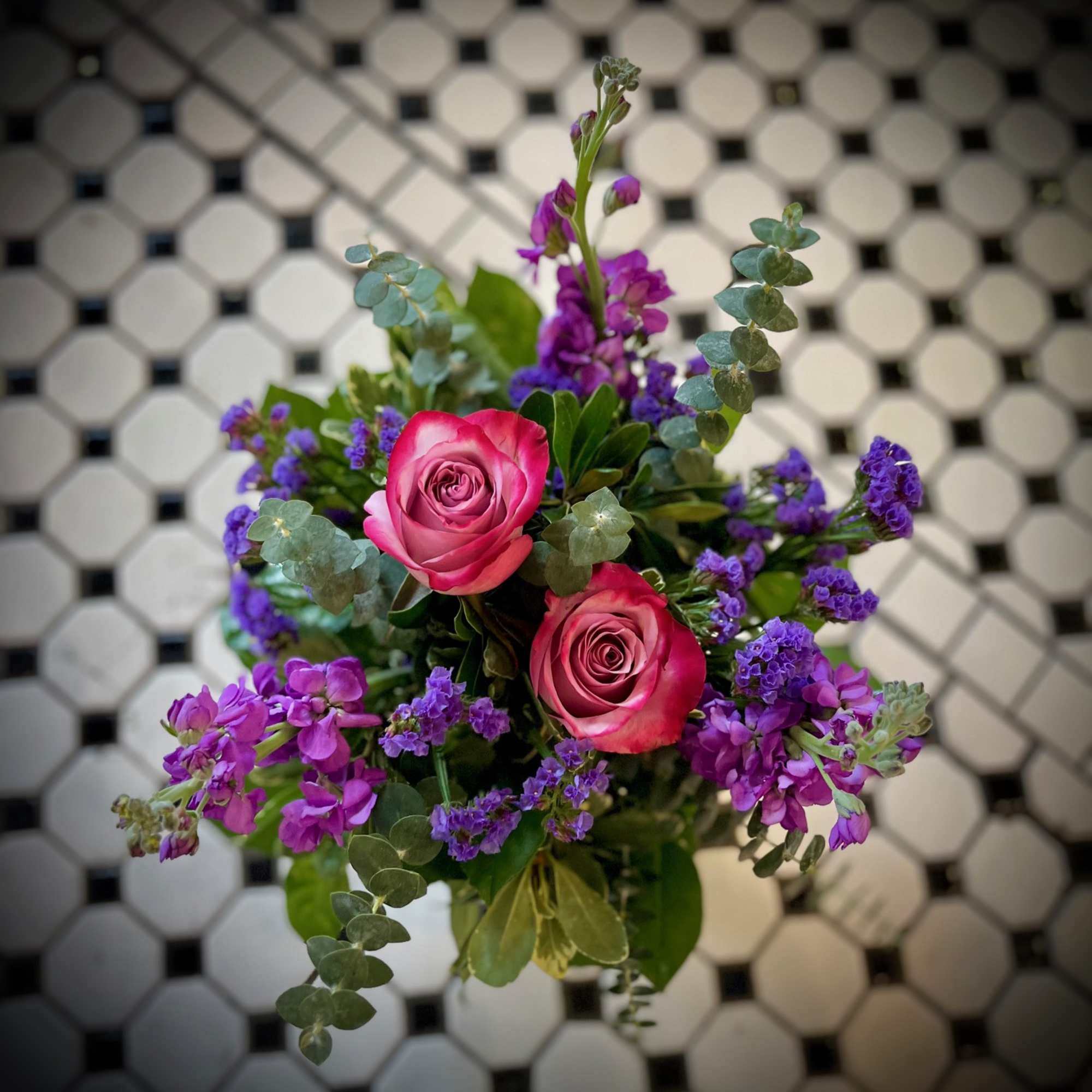 "Purple Passion" Is a beautiful monochromatic arrangement featuring two purple roses, purple