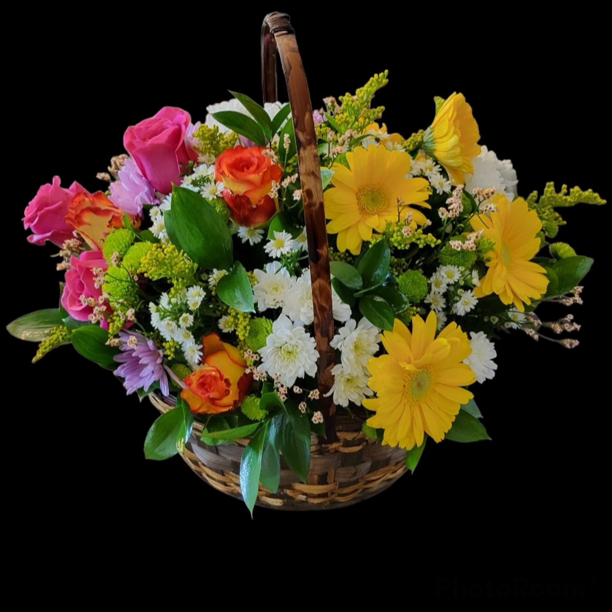 Mixed bouquet in a wicker basket with pink, yellow, orange, and white flowers