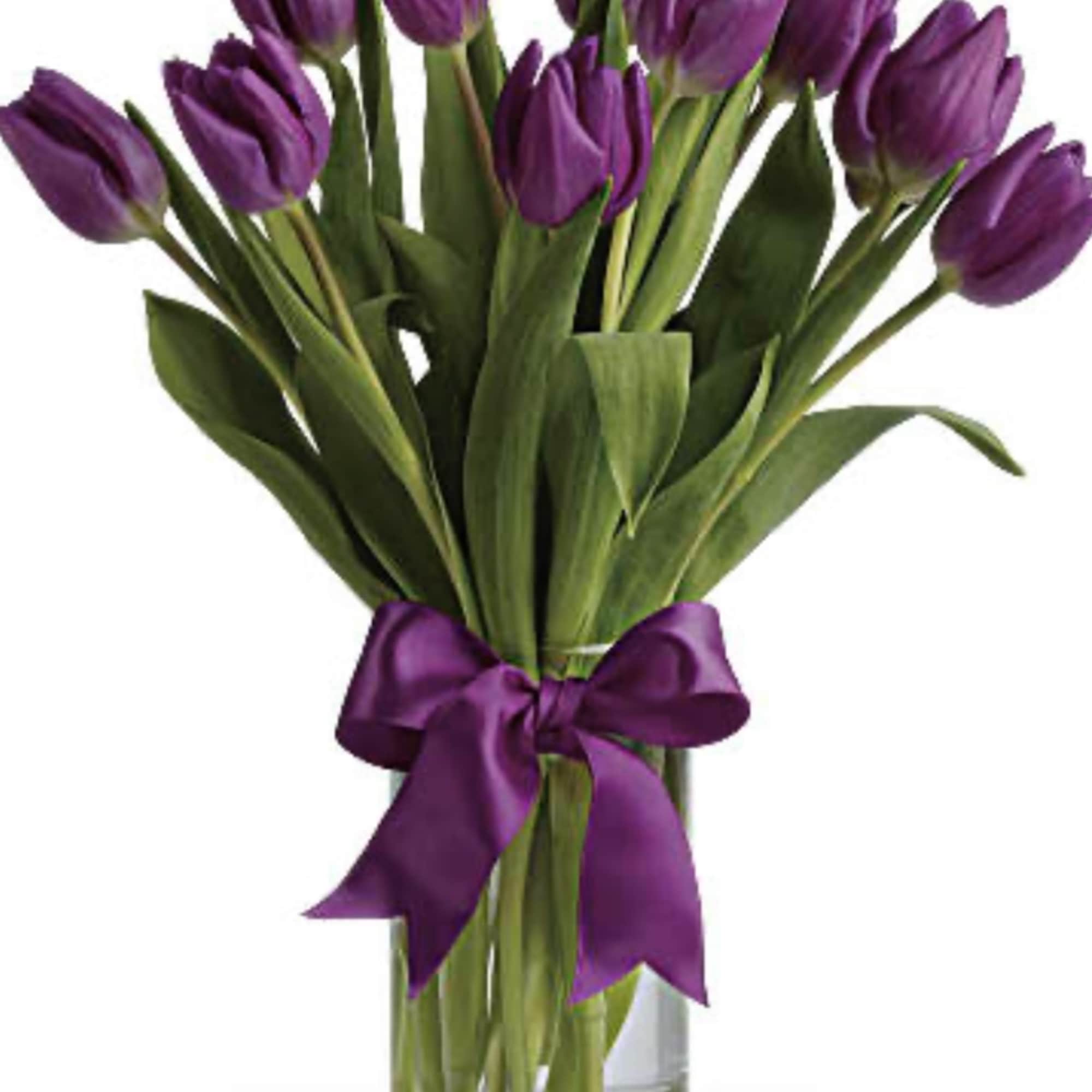 Purple tulip bouquet in a clear glass vase with a purple ribbon