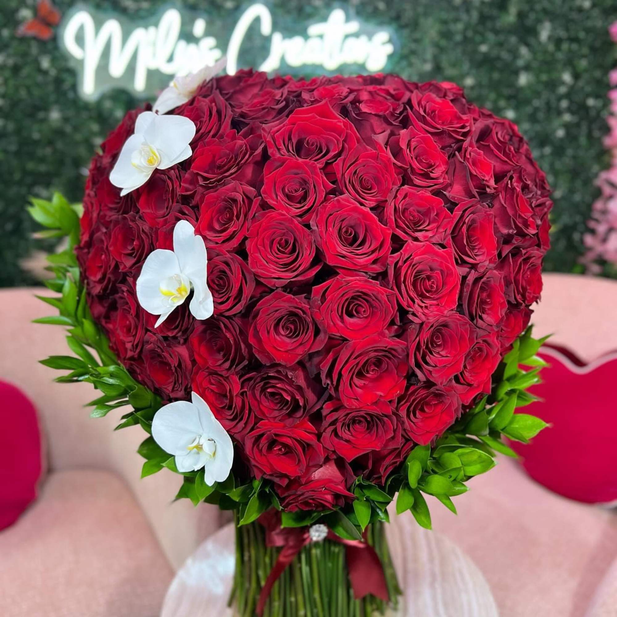 Heart-shaped bouquet of red roses with white orchids