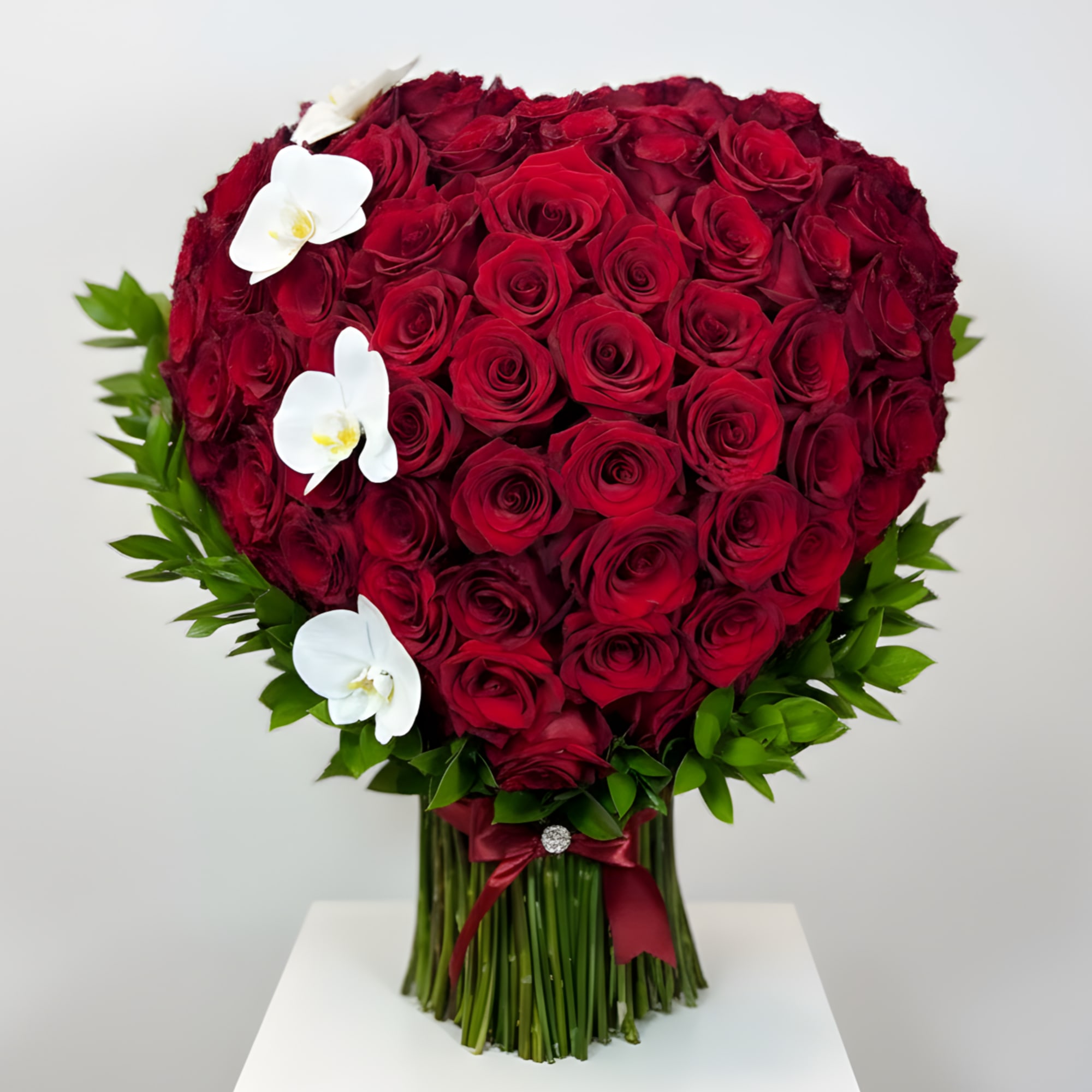 Heart-shaped bouquet of red roses with white orchids