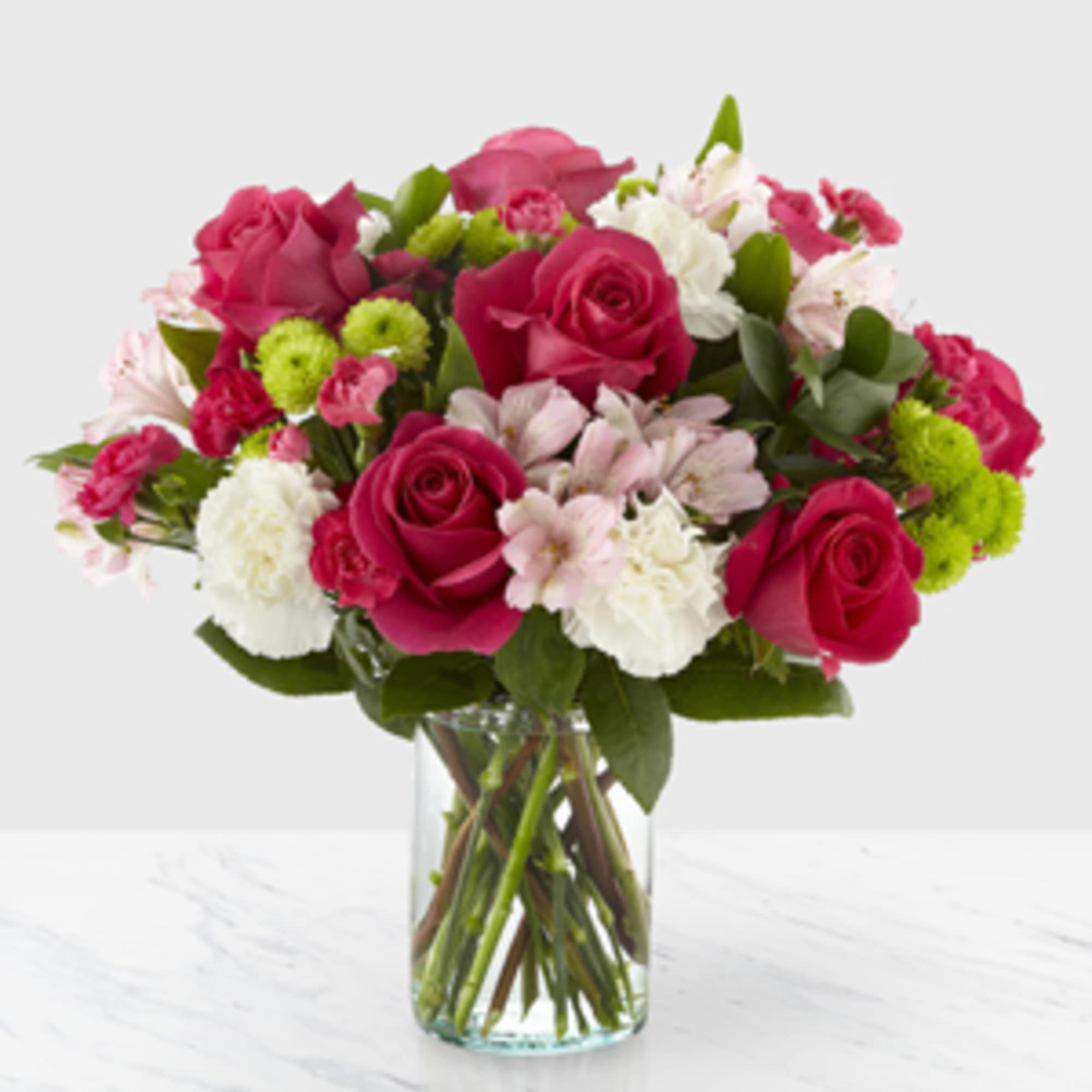Pink and white mixed bouquet in a clear glass vase