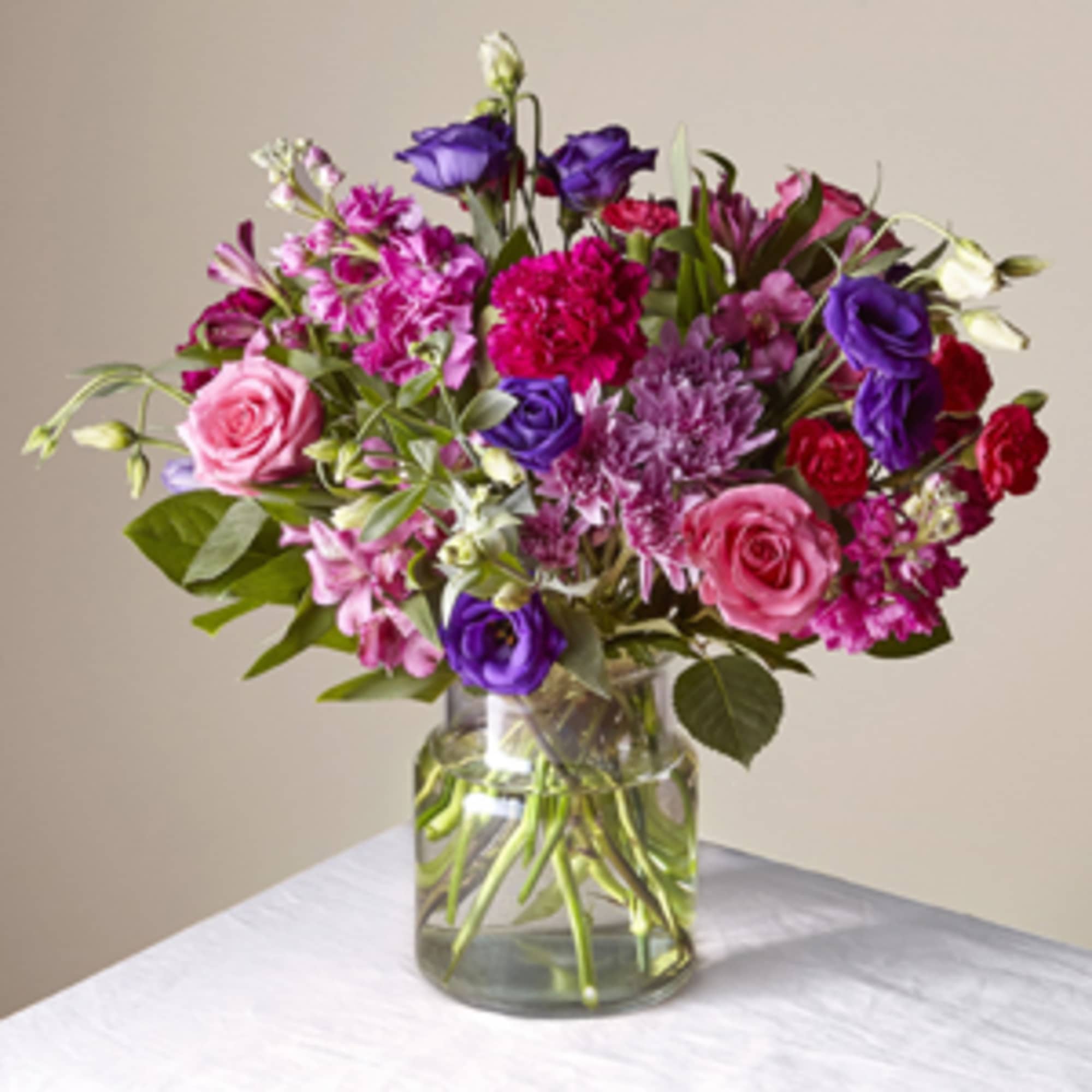 Mixed pink and purple bouquet in a clear glass vase