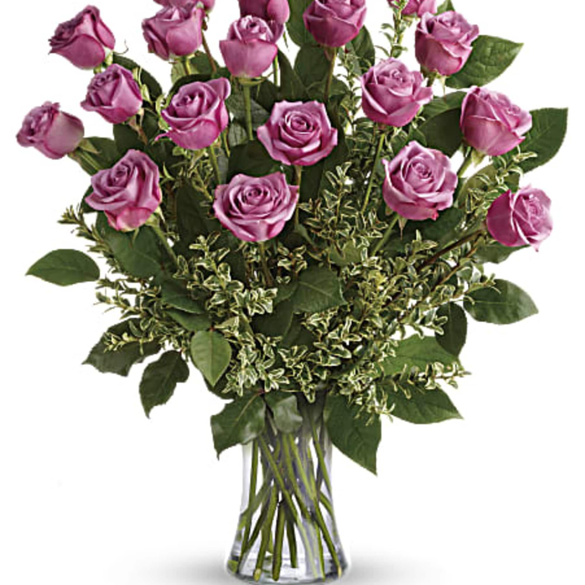Tall arrangement of lavender roses with variegated greenery in a clear glass vase