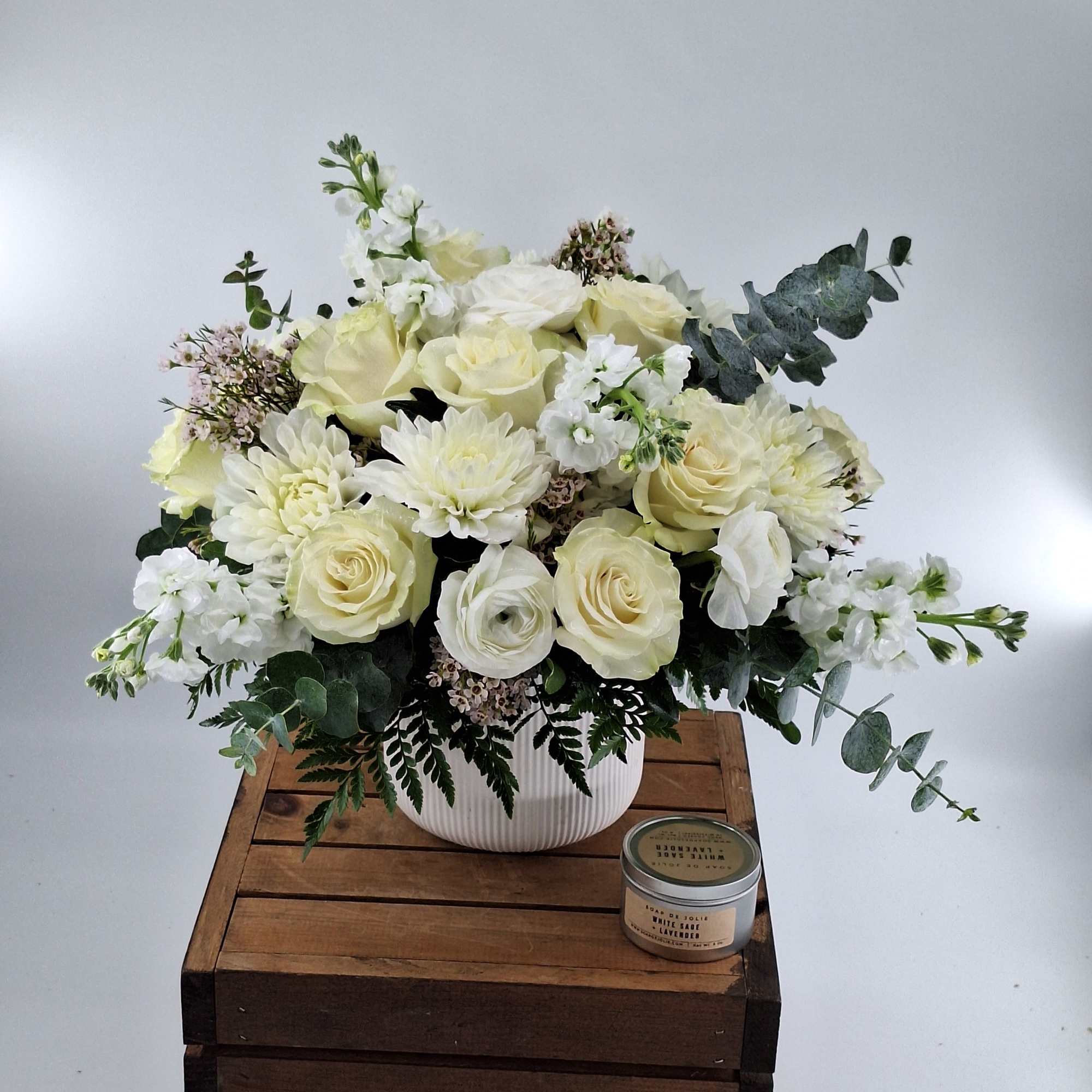 Cream rose and white chrysanthemum arrangement in a ribbed white vase