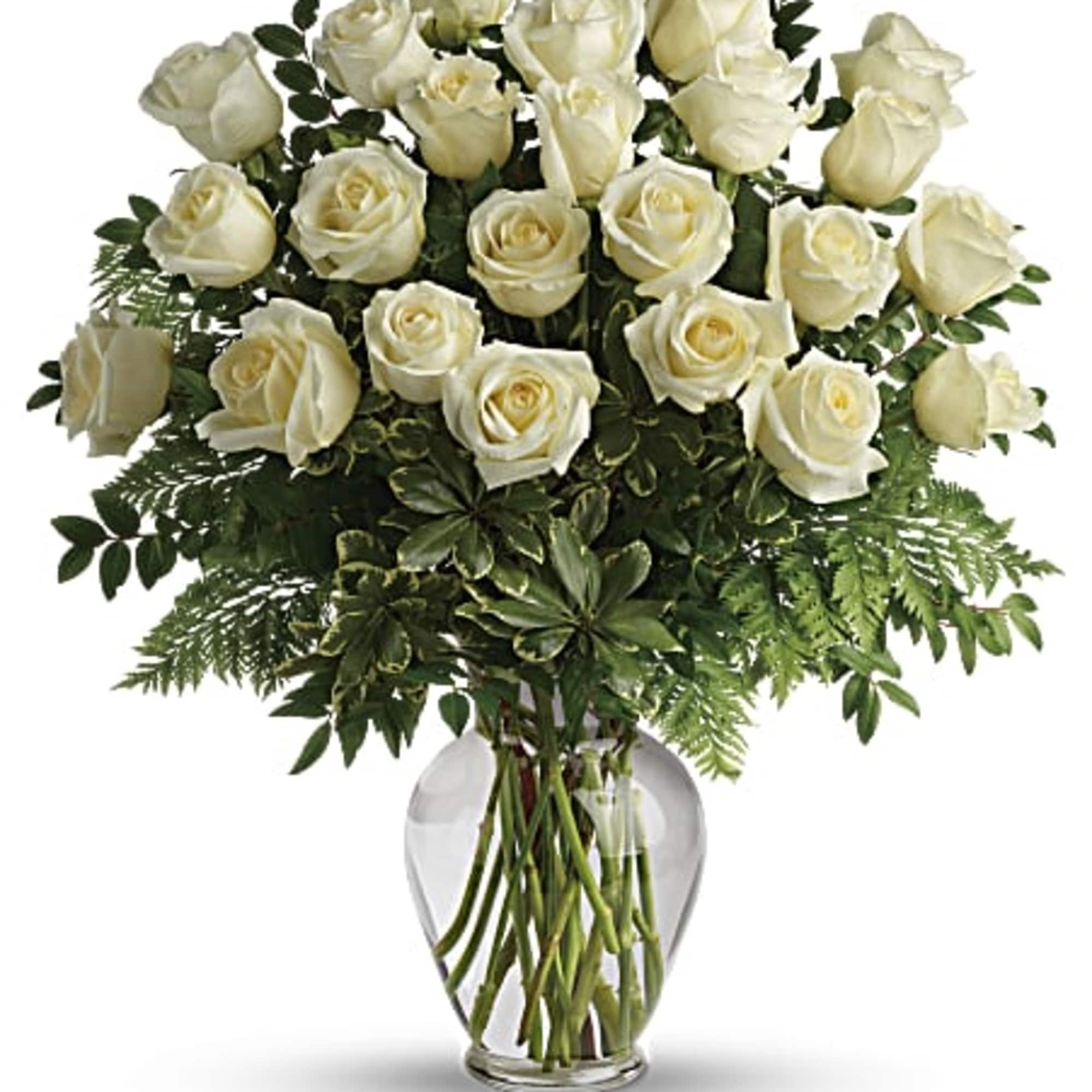Tall bouquet of white roses in a clear glass vase