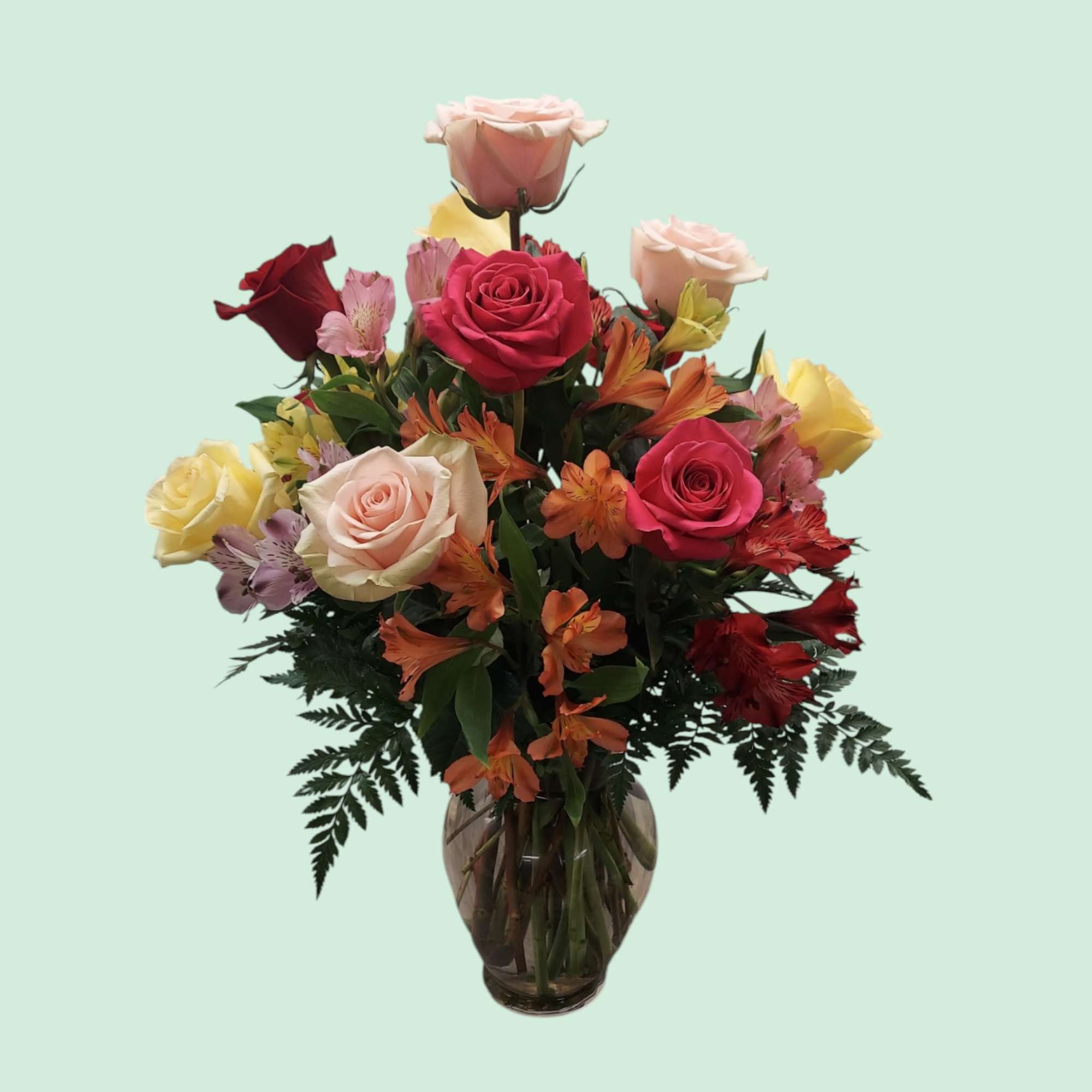 Mixed roses and alstroemeria in a glass vase