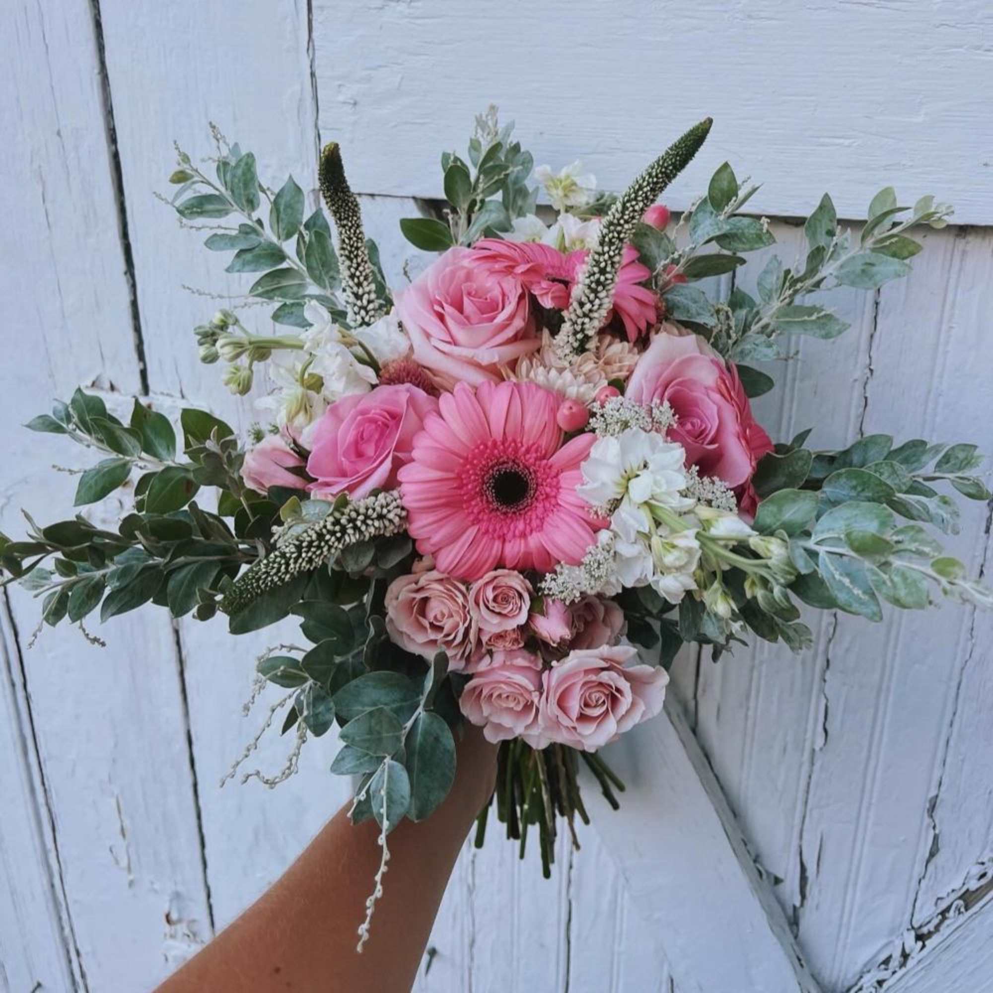 Pink rose bouquet with a pink gerbera daisy and white flowers