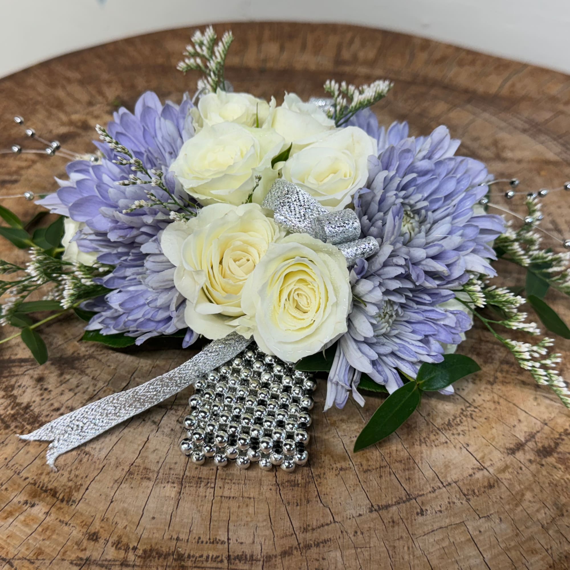 Lavender and white floral arrangement with silver ribbon and bead accents