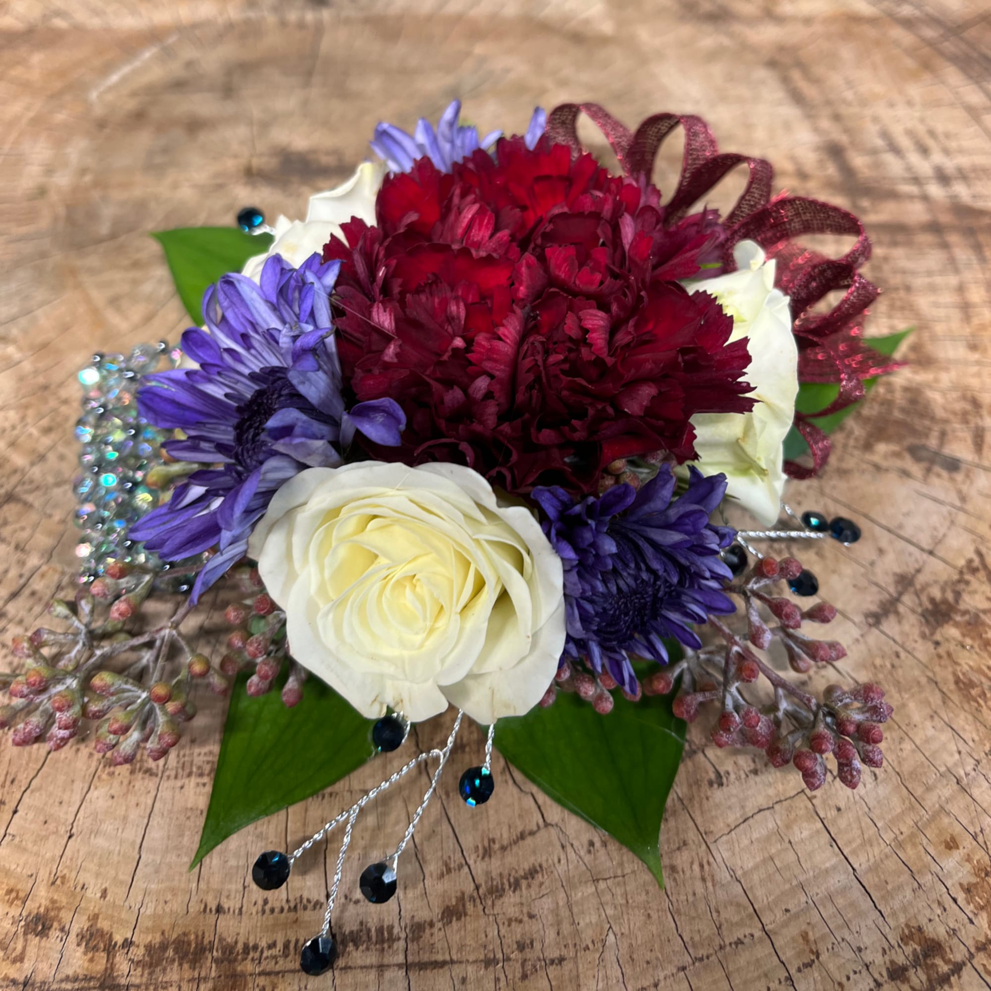 Compact bouquet with white roses, purple daisies, and deep red blooms