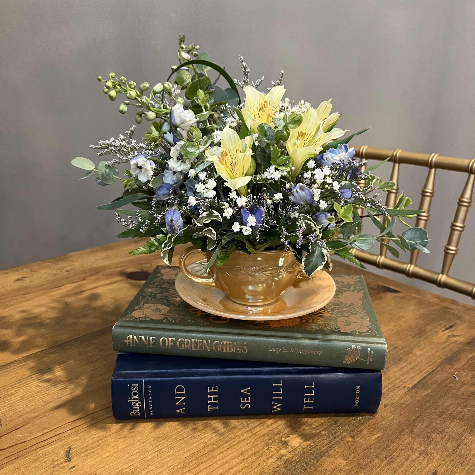 A mix of garden blooms designed in a vintage tea cup. Each