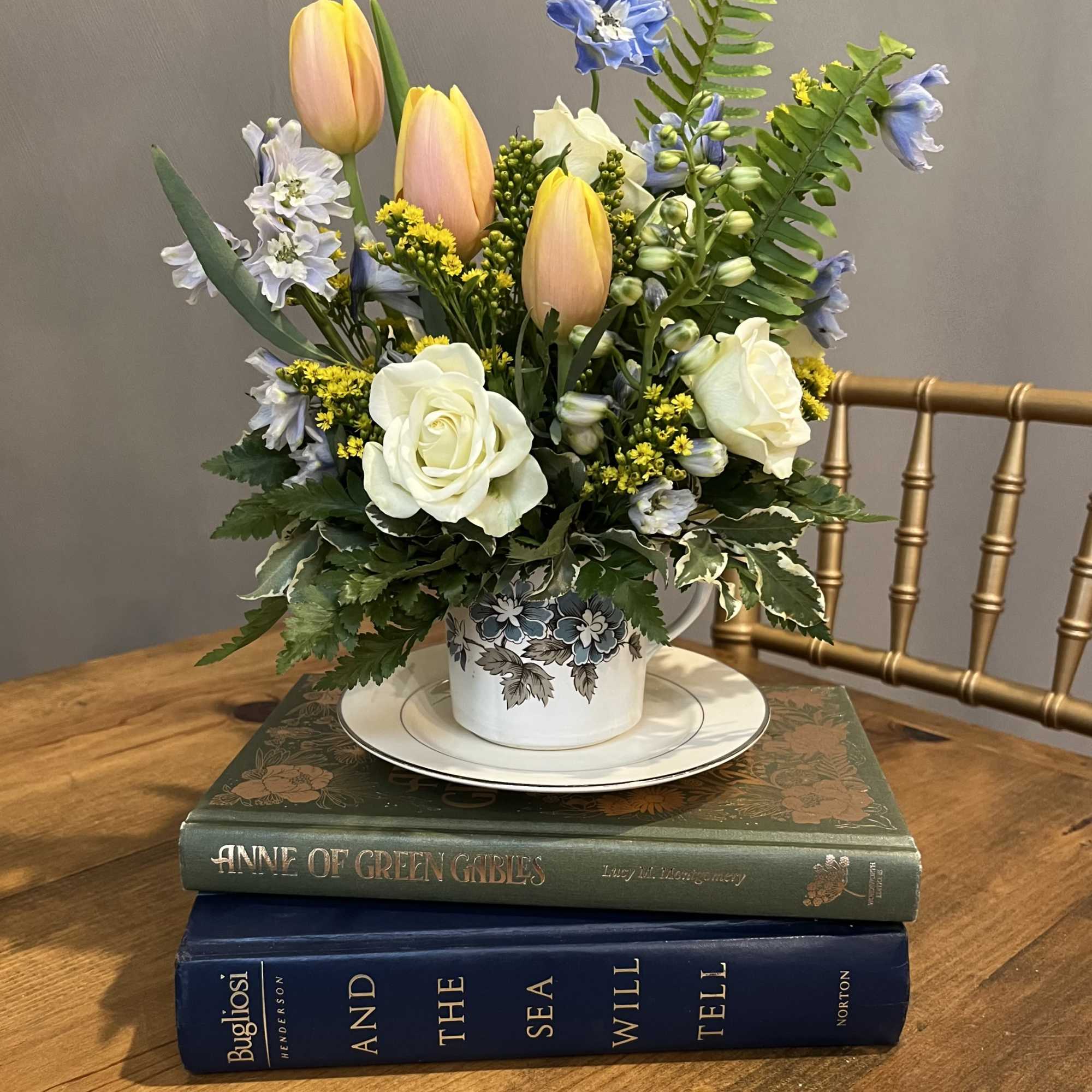 A mix of garden blooms designed in a vintage tea cup. Each