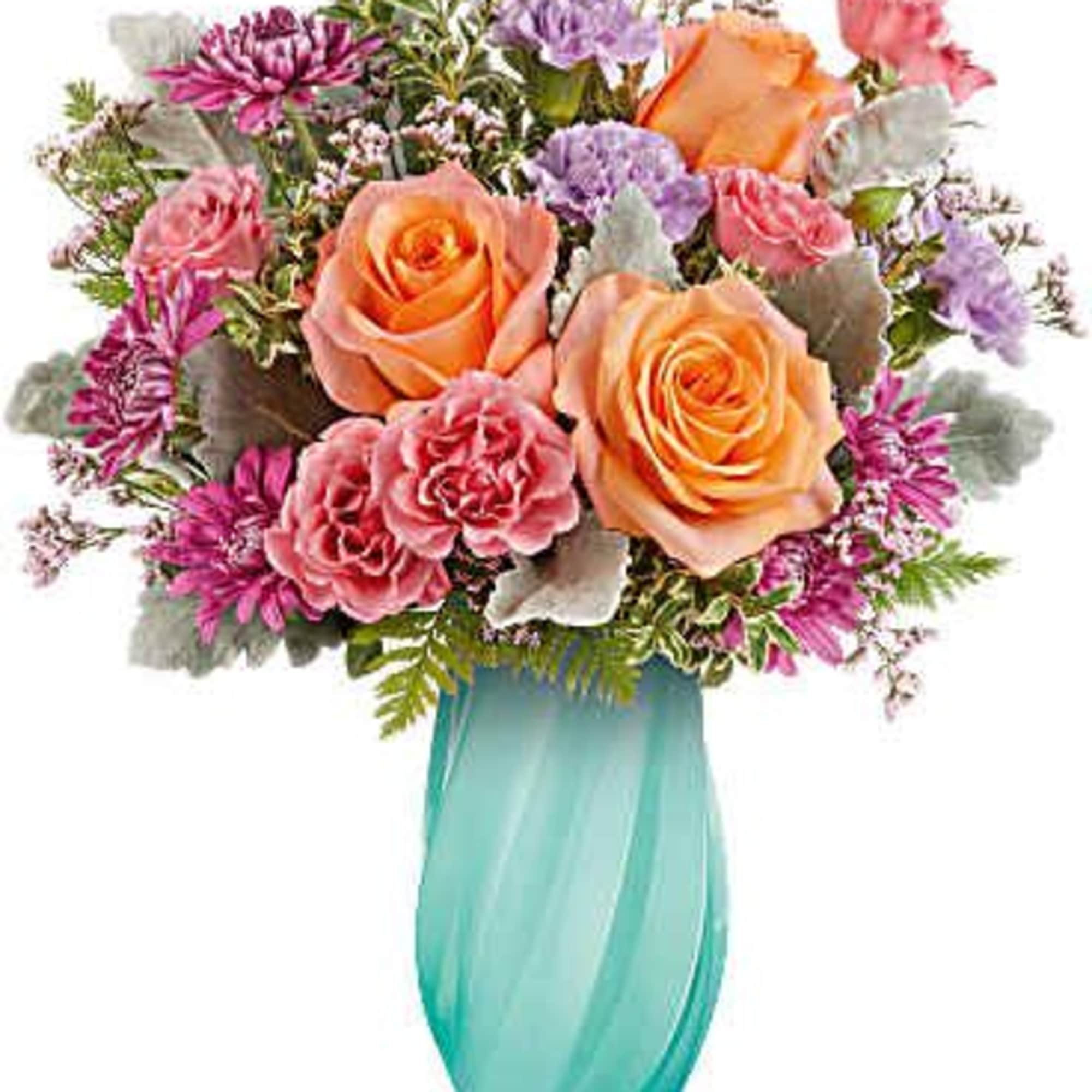 Bouquet of peach and pink roses in a turquoise vase