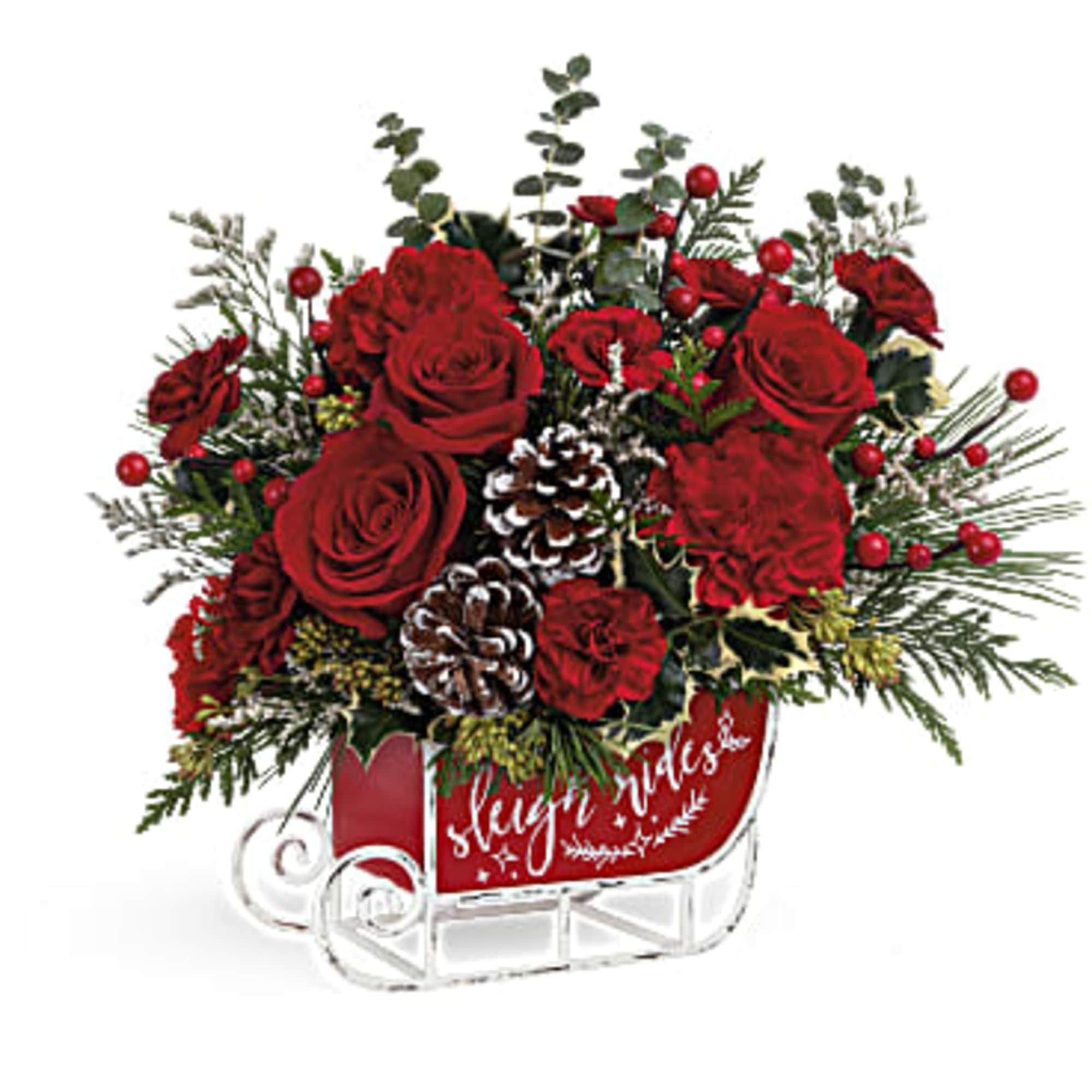 Red roses and pinecones in a red sleigh container
