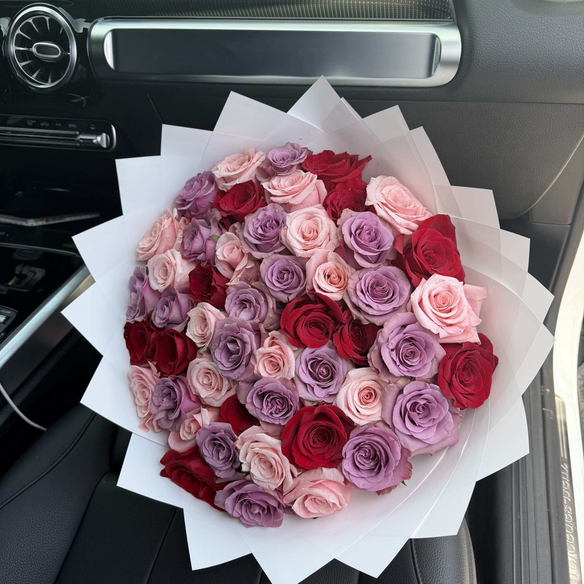 This unique and playful bouquet features two-toned roses surrounded by a mix