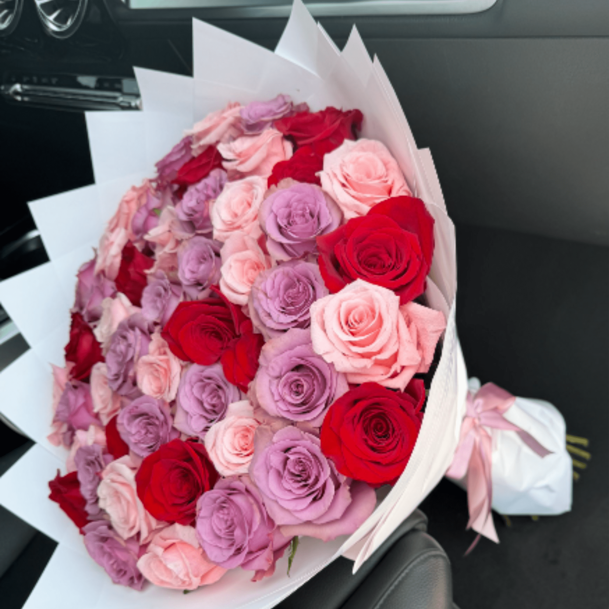 This unique and playful bouquet features two-toned roses surrounded by a mix