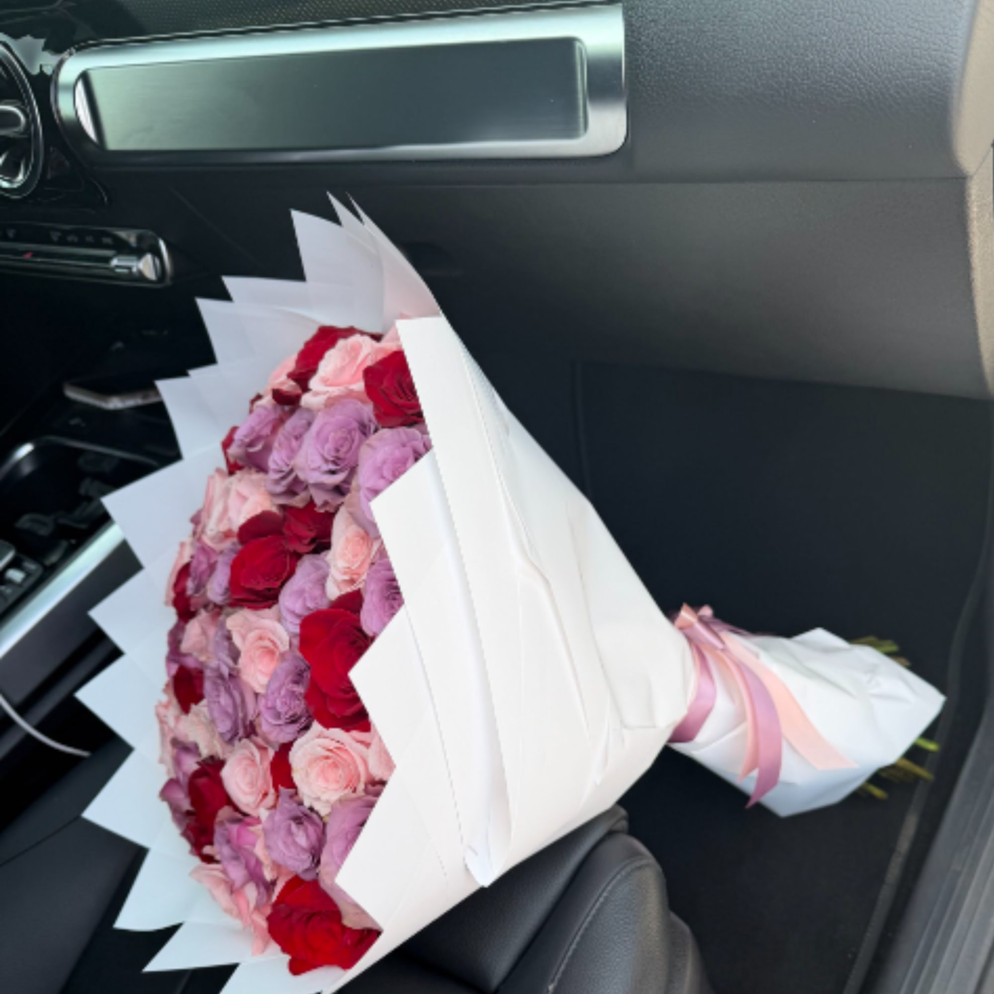 This unique and playful bouquet features two-toned roses surrounded by a mix