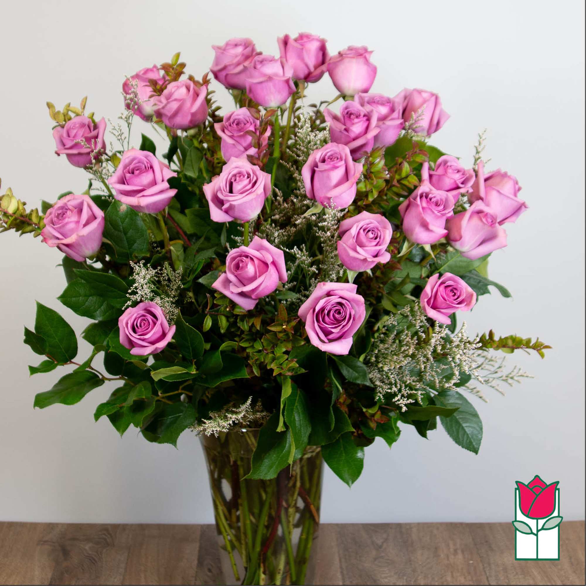 Pink roses arranged in a clear glass vase