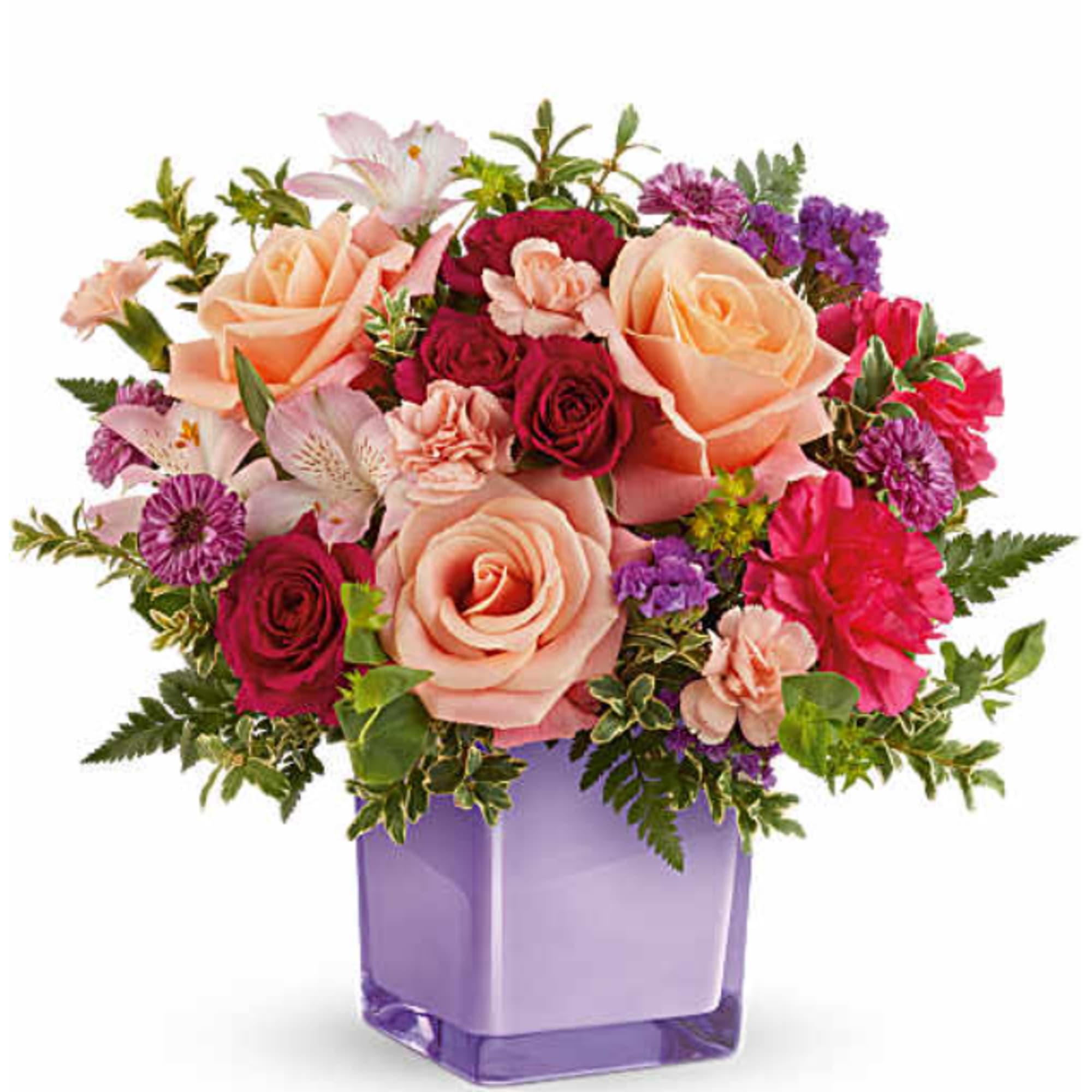Teleflora's Sunset Sorbet Bouquet includes peach roses, hot pink spray roses, light