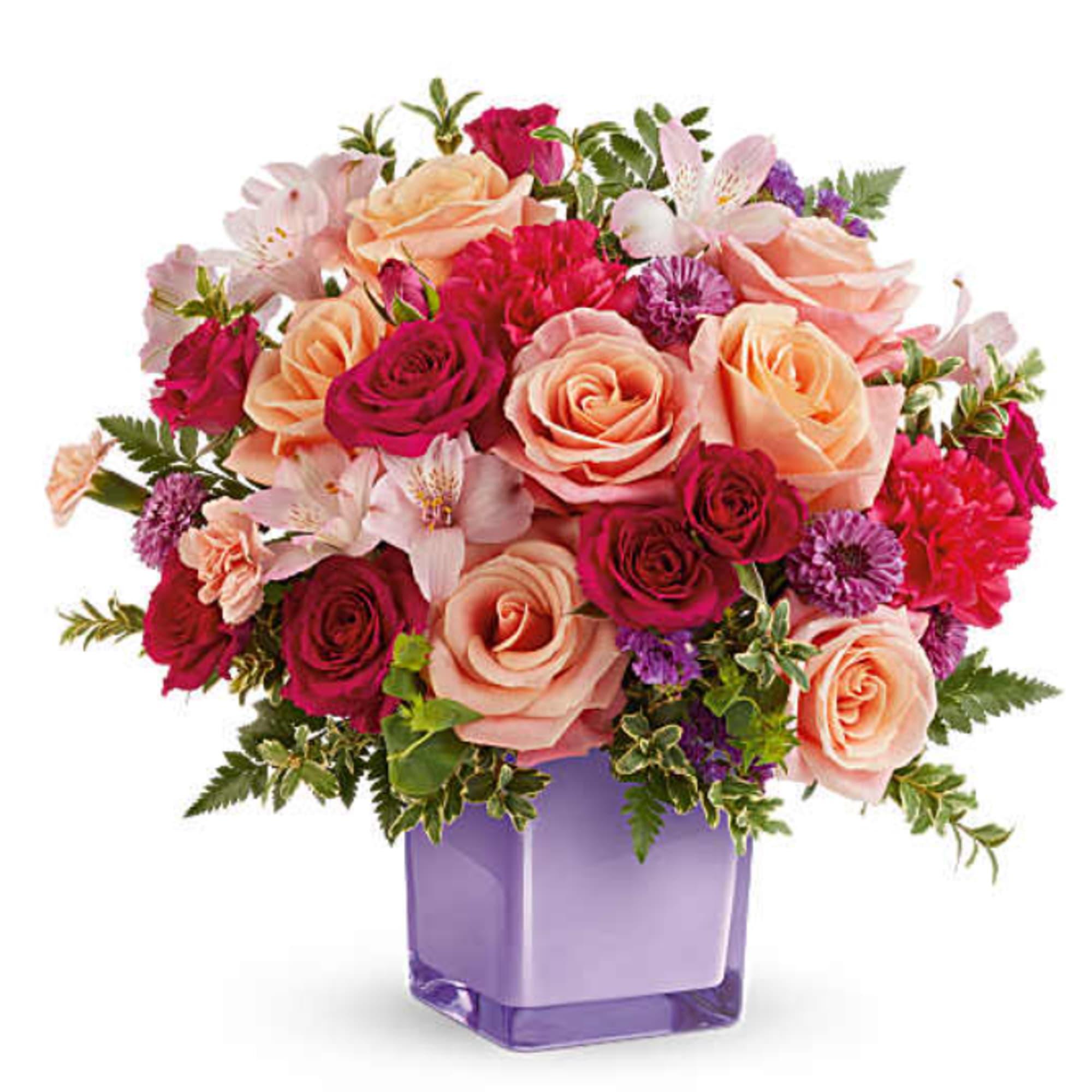 Teleflora's Sunset Sorbet Bouquet includes peach roses, hot pink spray roses, light