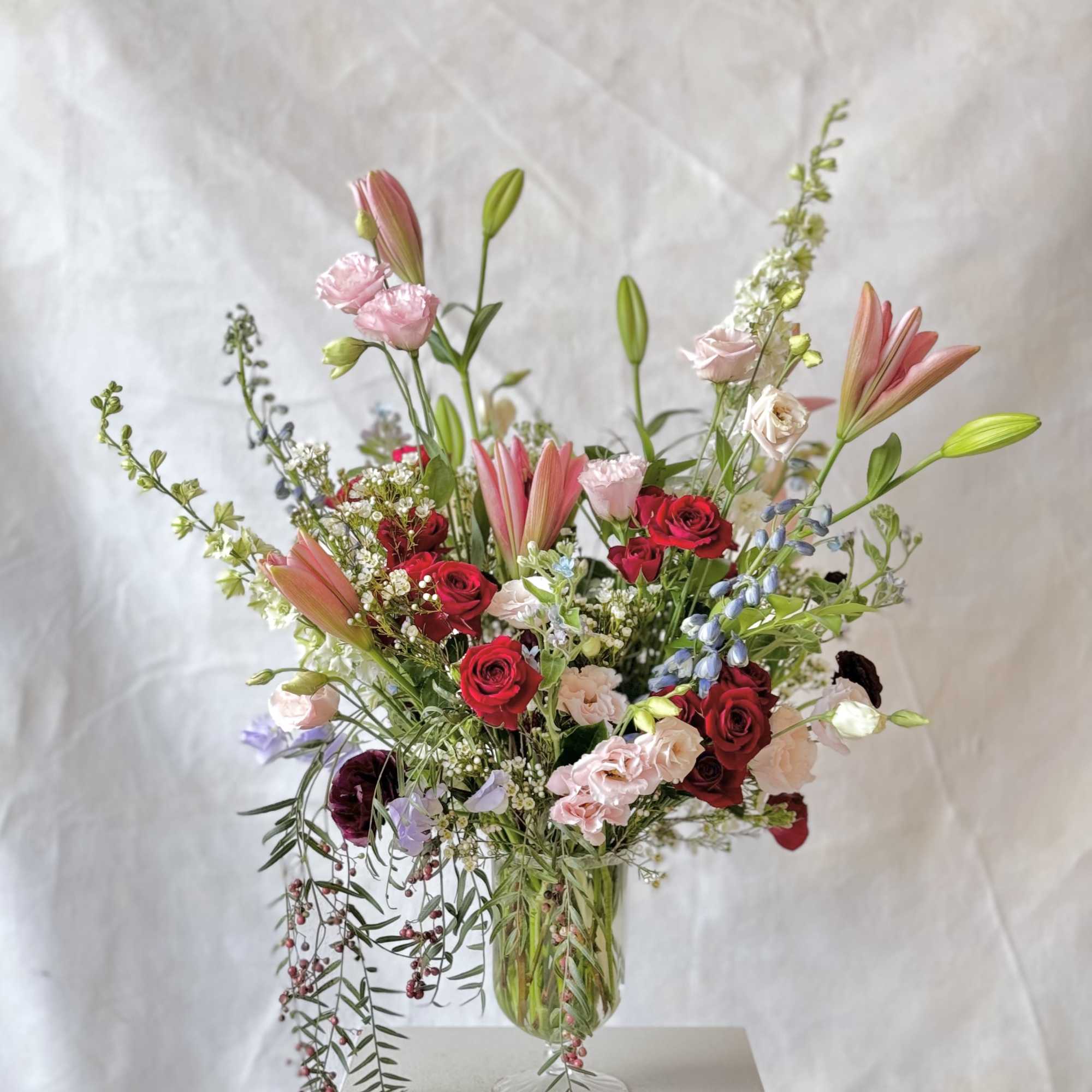 This radiant arrangement embodies joy and compassion, blending rich hues and lush
