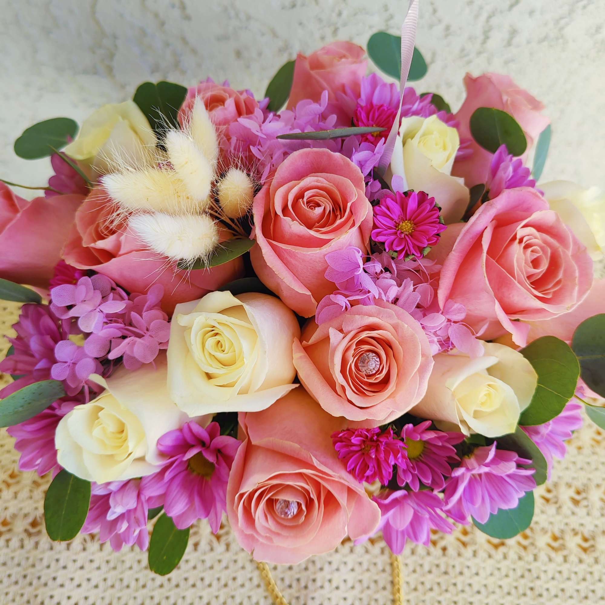 Pink and cream rose bouquet with purple daisies and fluffy accents