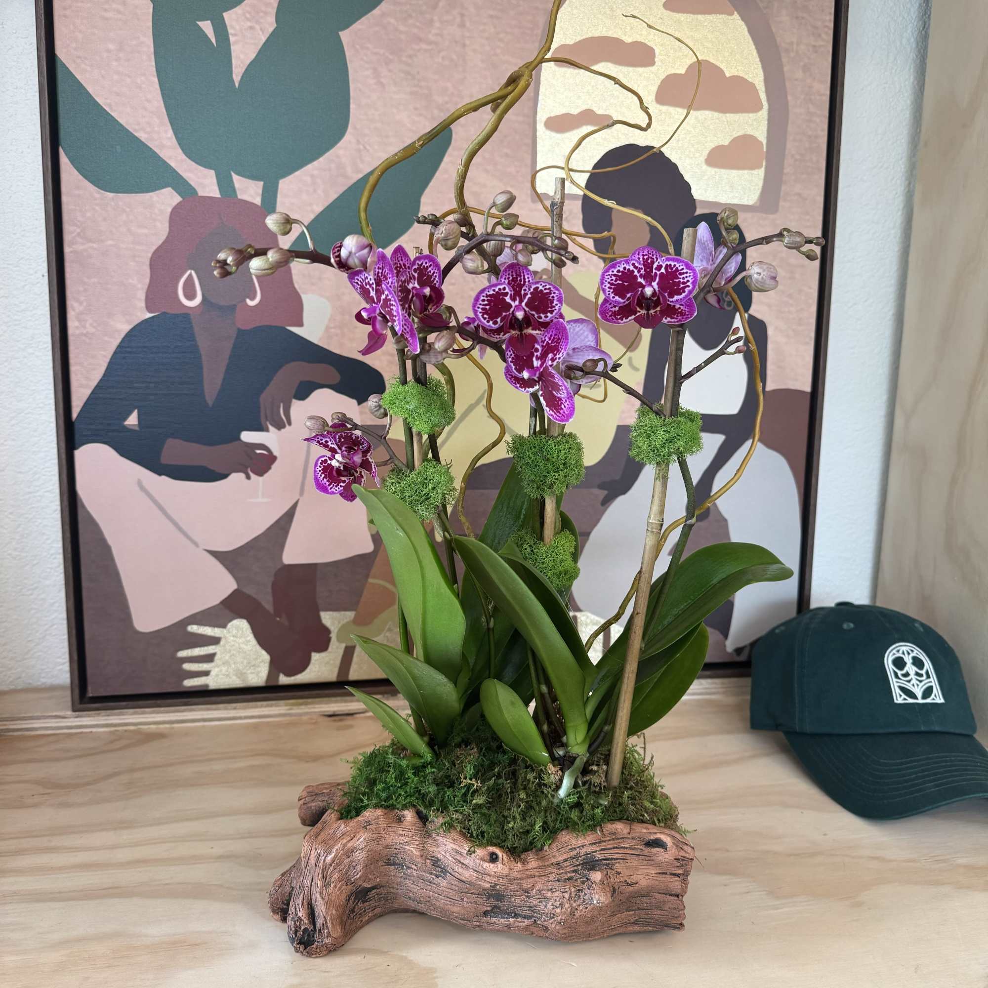 Potted purple orchids arranged in a driftwood planter
