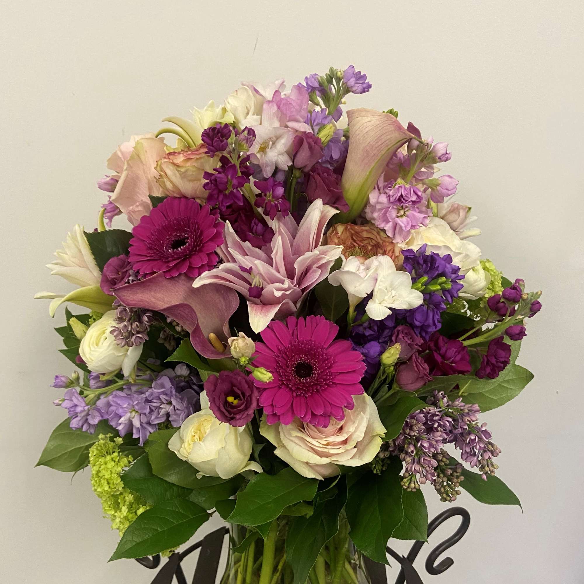 Mixed pink and purple bouquet in a glass vase