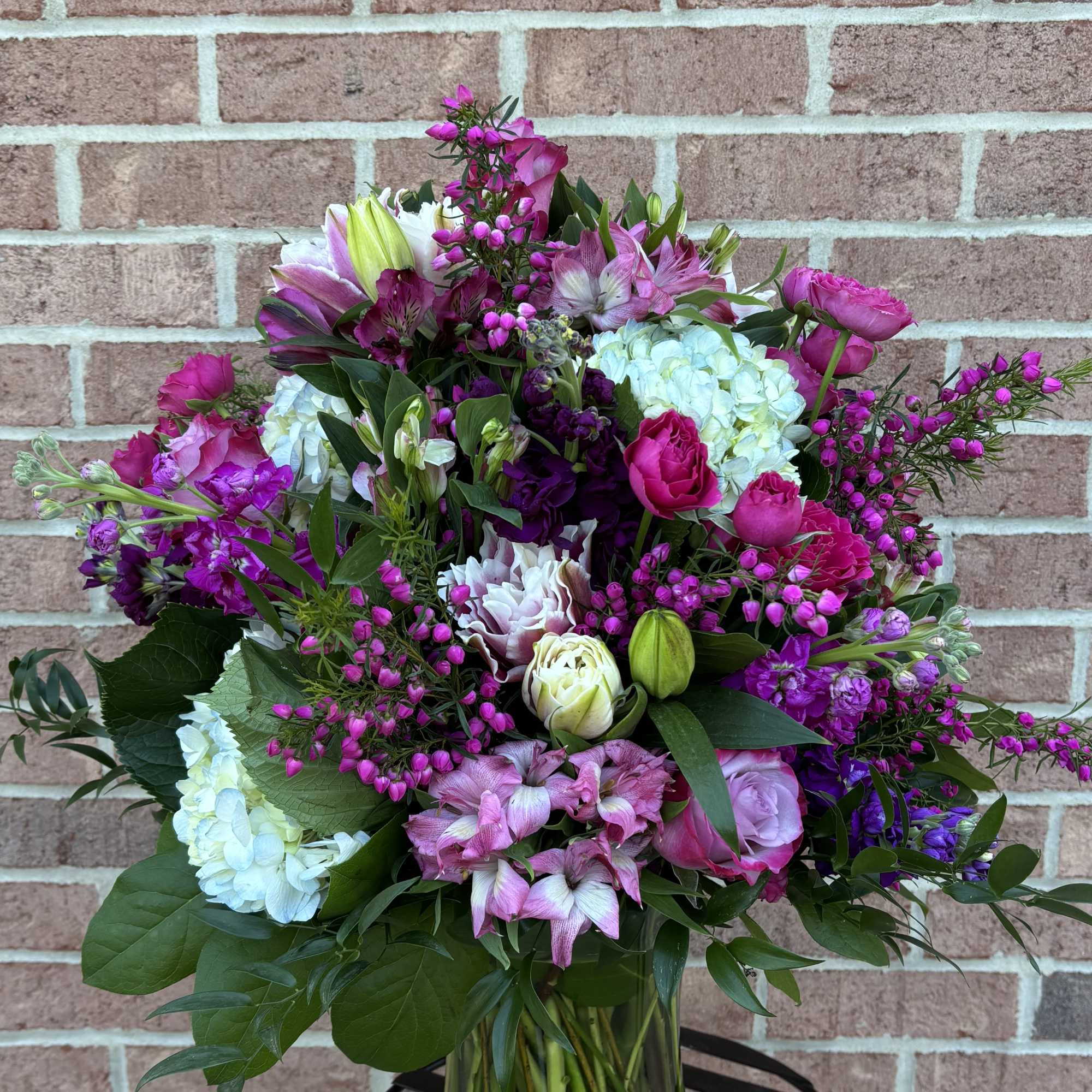 Mixed pink and purple bouquet in a clear glass vase