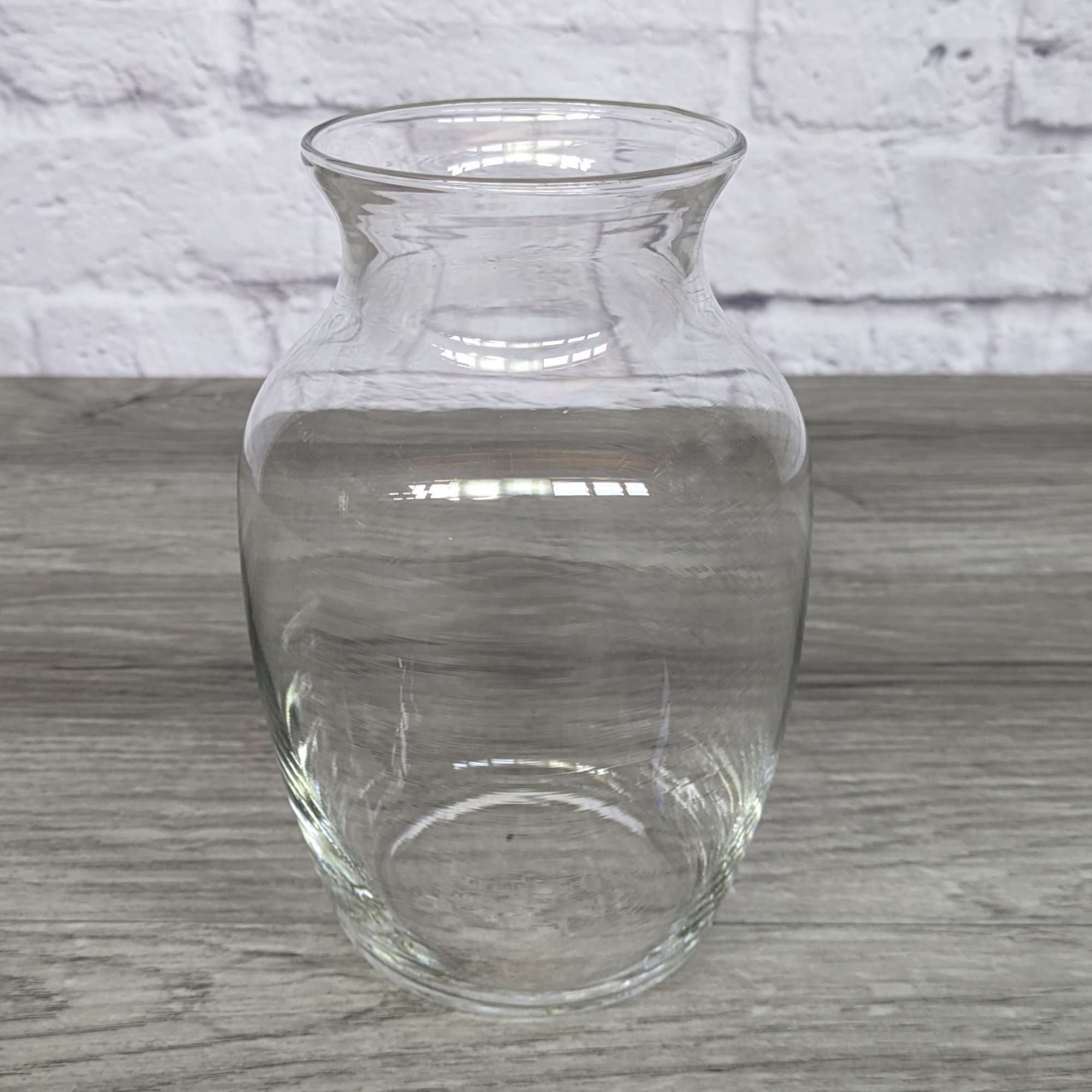 Clear glass vase on a wood surface