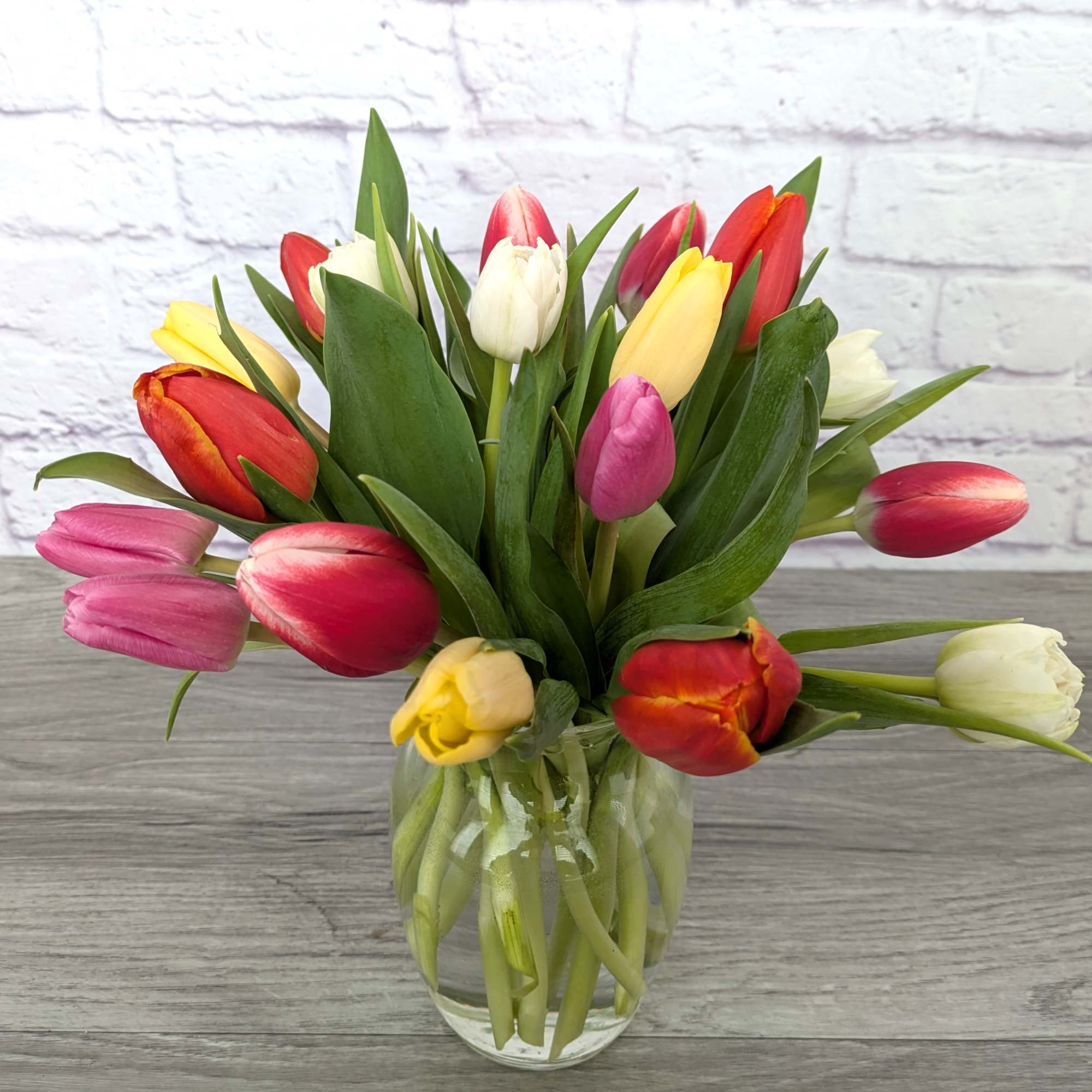 Mixed tulips in a clear glass vase