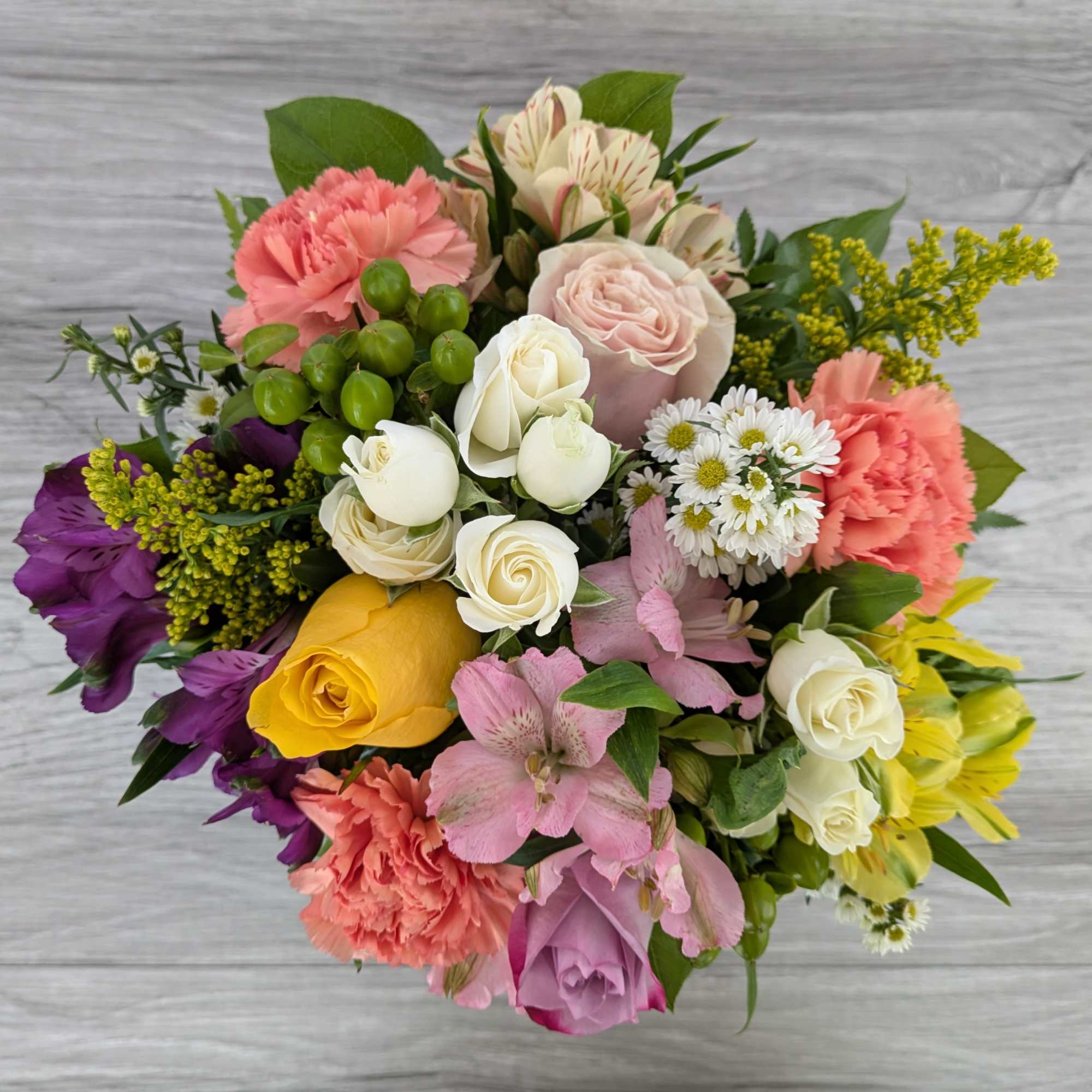 Mixed bouquet with roses, carnations, and alstroemeria in bright colors
