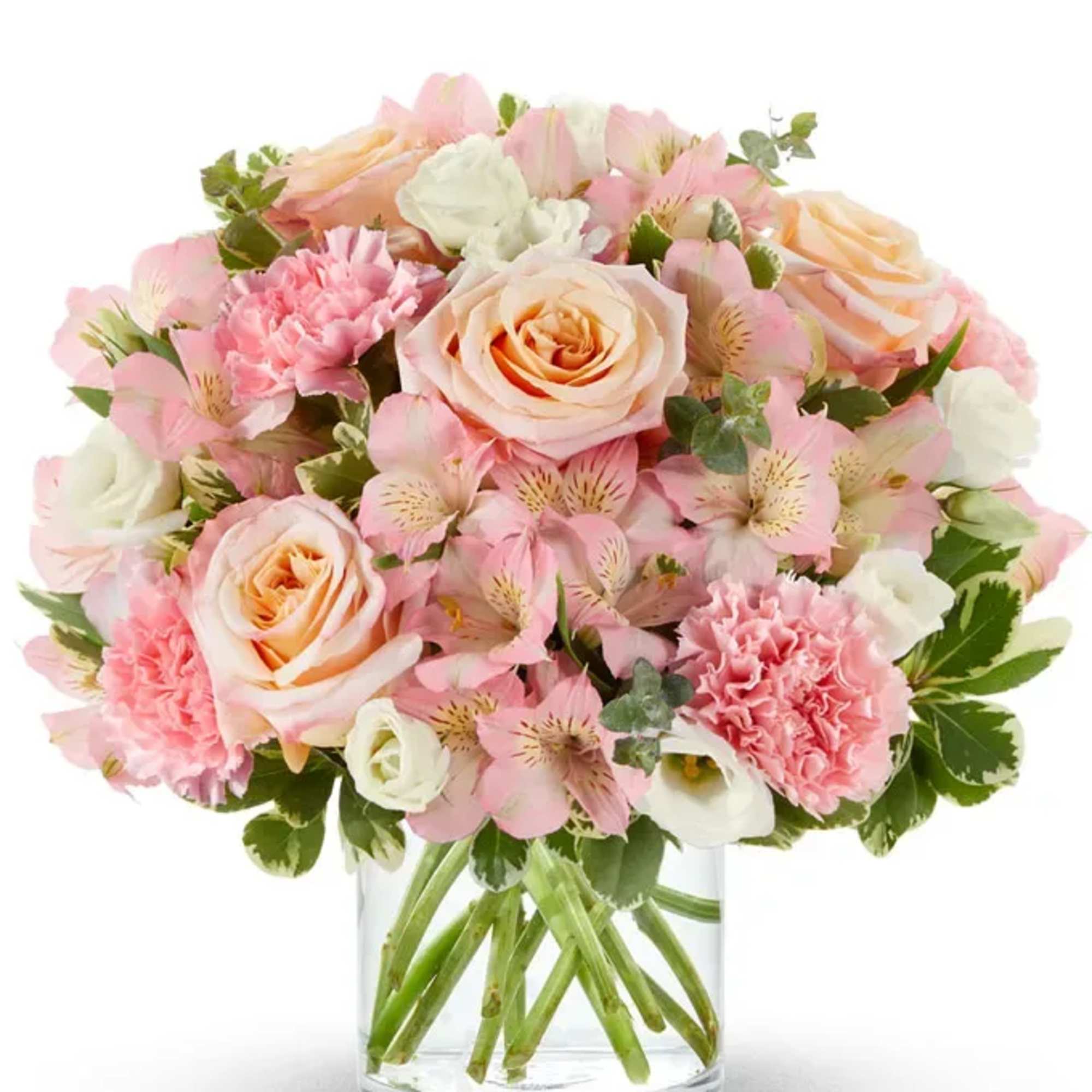 Pink and peach bouquet of roses, carnations, and alstroemeria in a clear glass vase