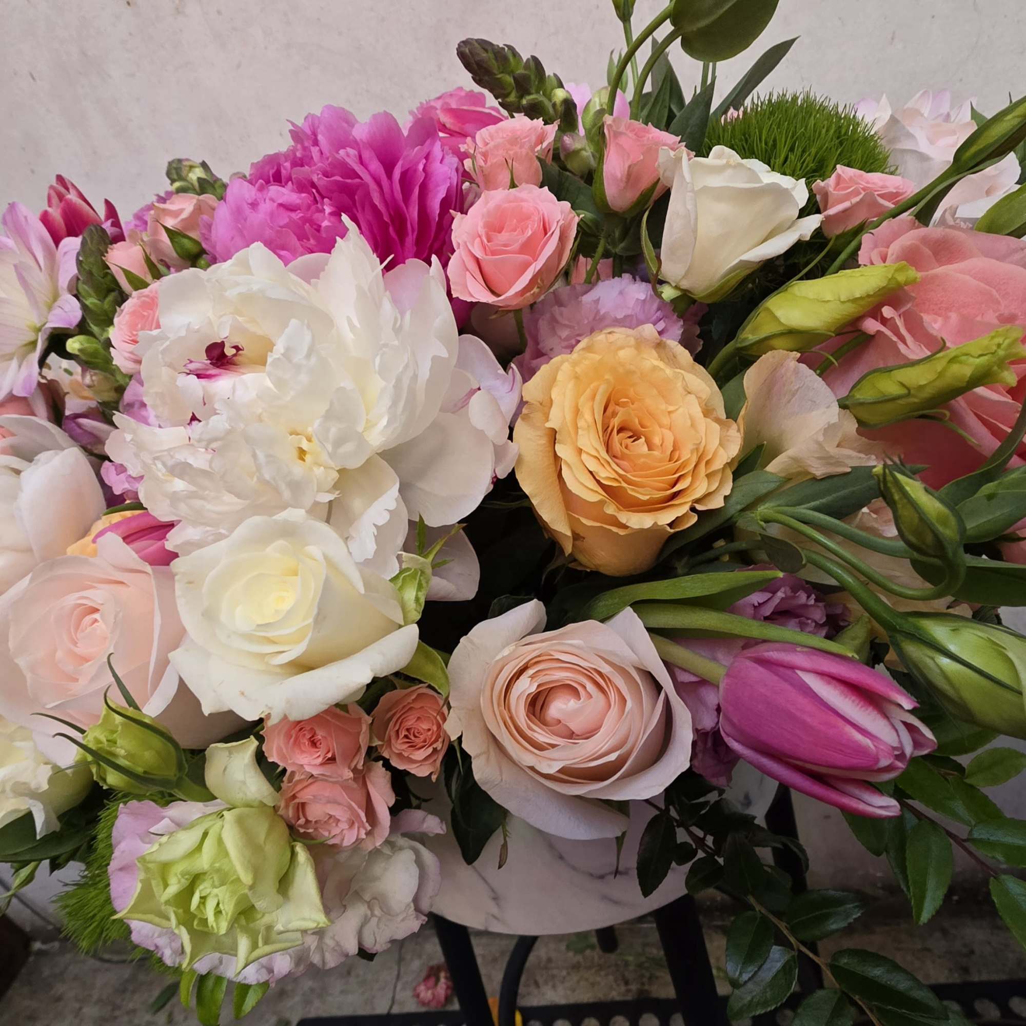 Mixed bouquet of pink, white, and peach flowers