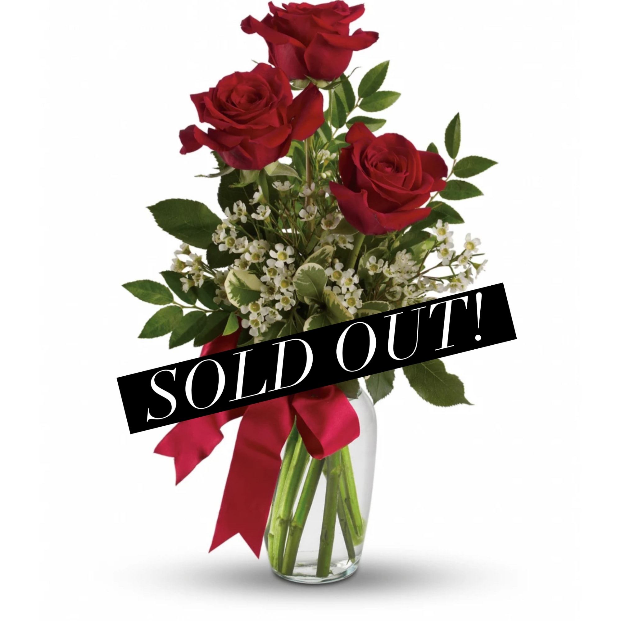Red roses in a clear glass vase with a red ribbon
