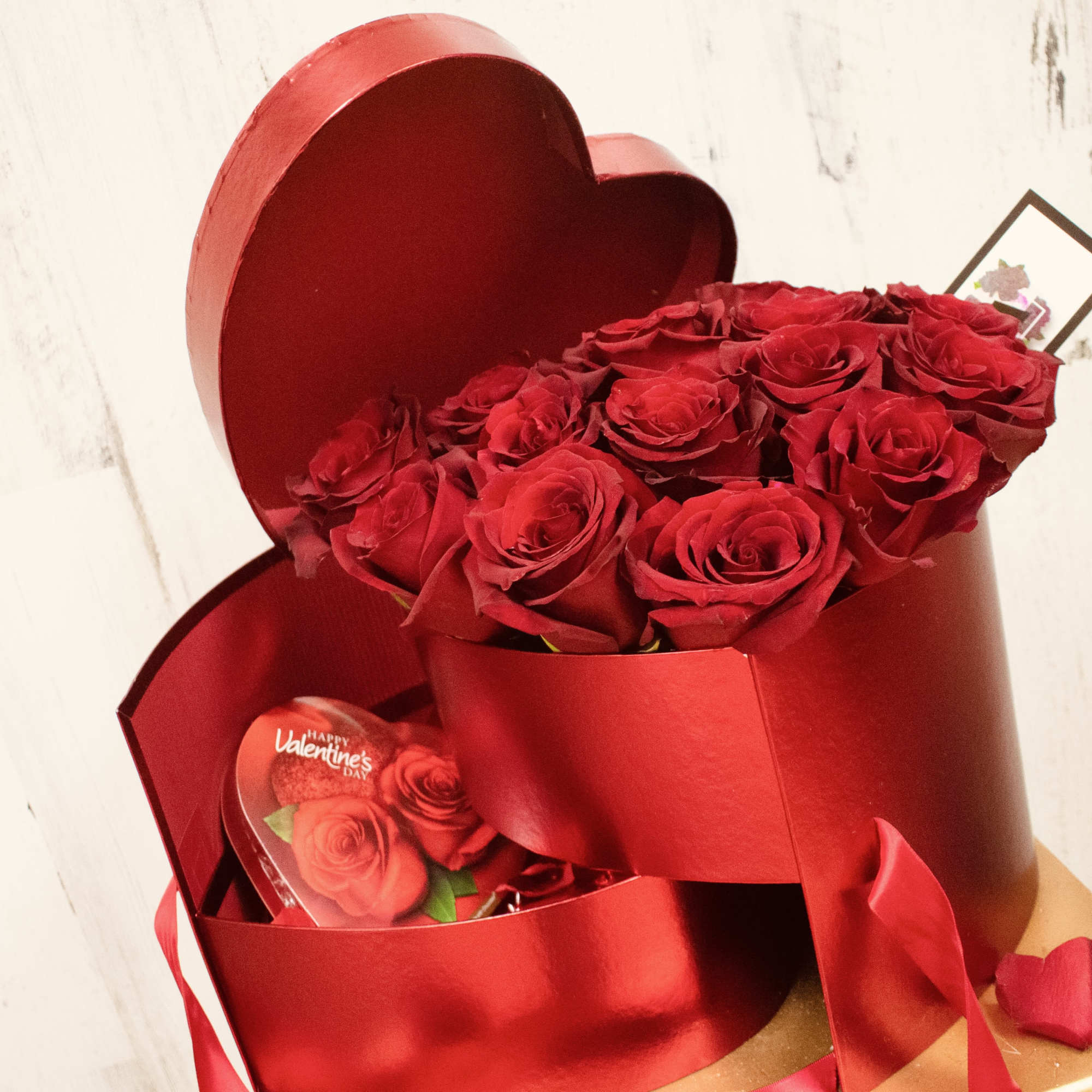 Deep metallic red heart shaped box comes with two compartments. Top compartment