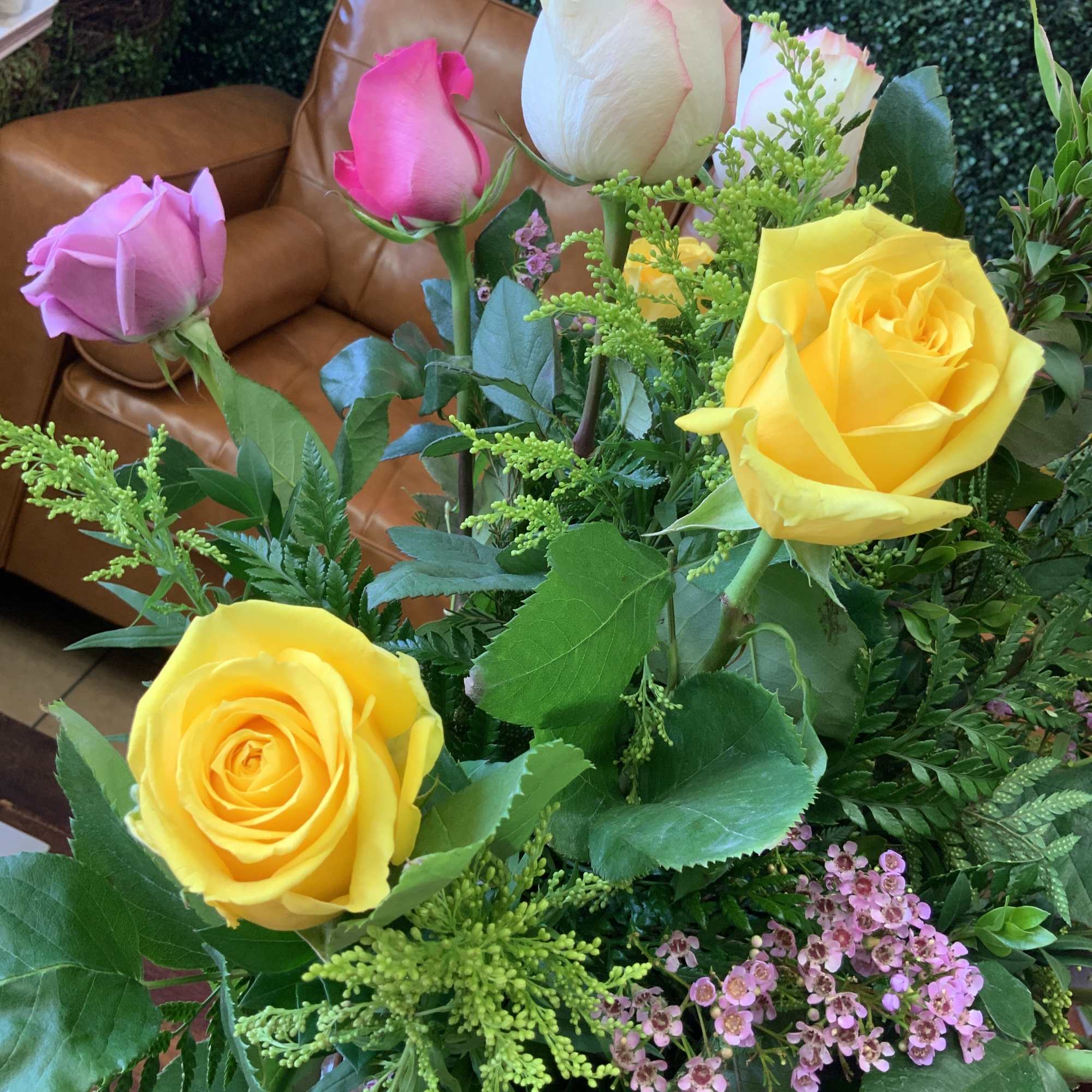 Beautiful Ecuadorian long stem roses arranged tall in a glass vase with