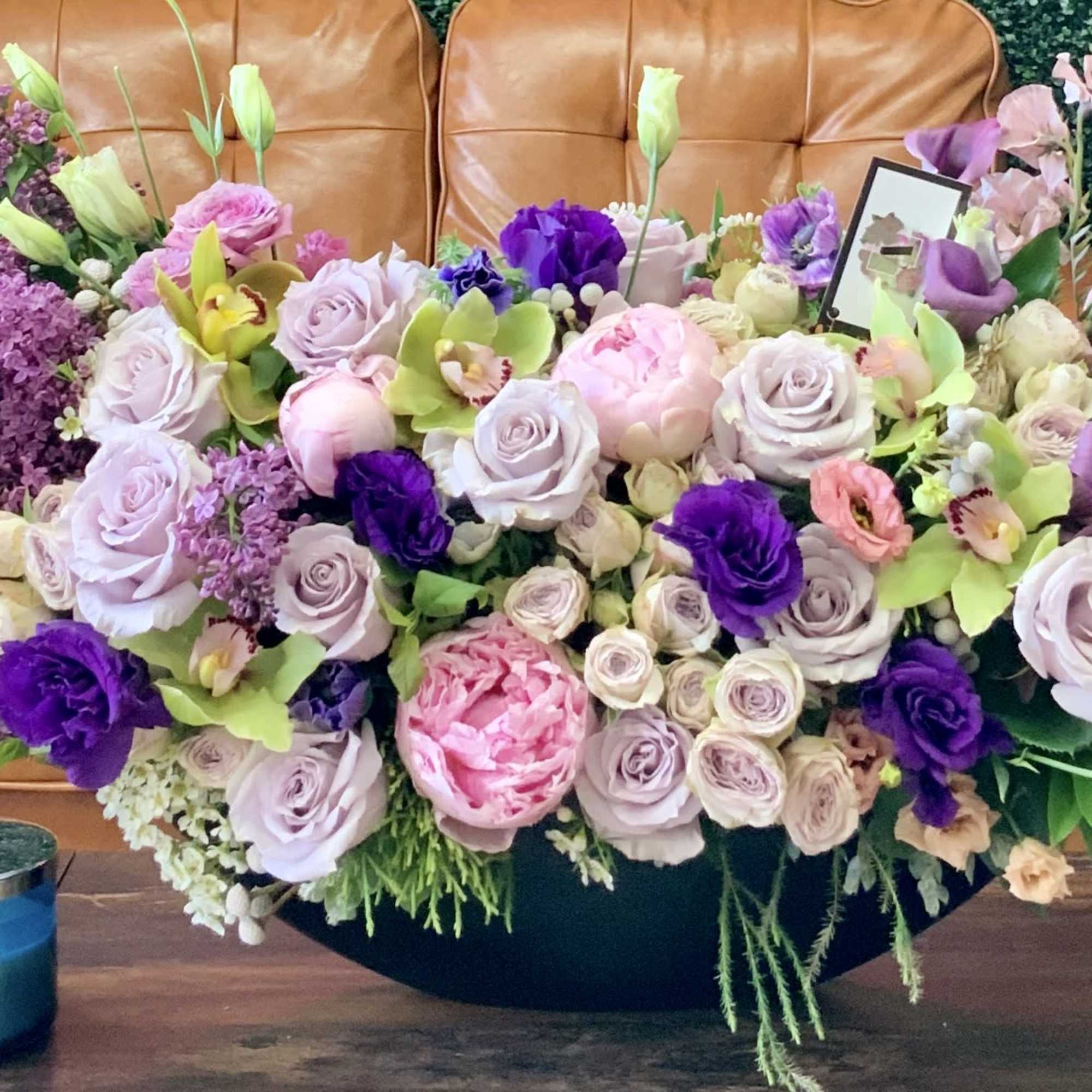 Lilacs, peonies, orchids oh my! Stunning unique floral arrangement sure to wow