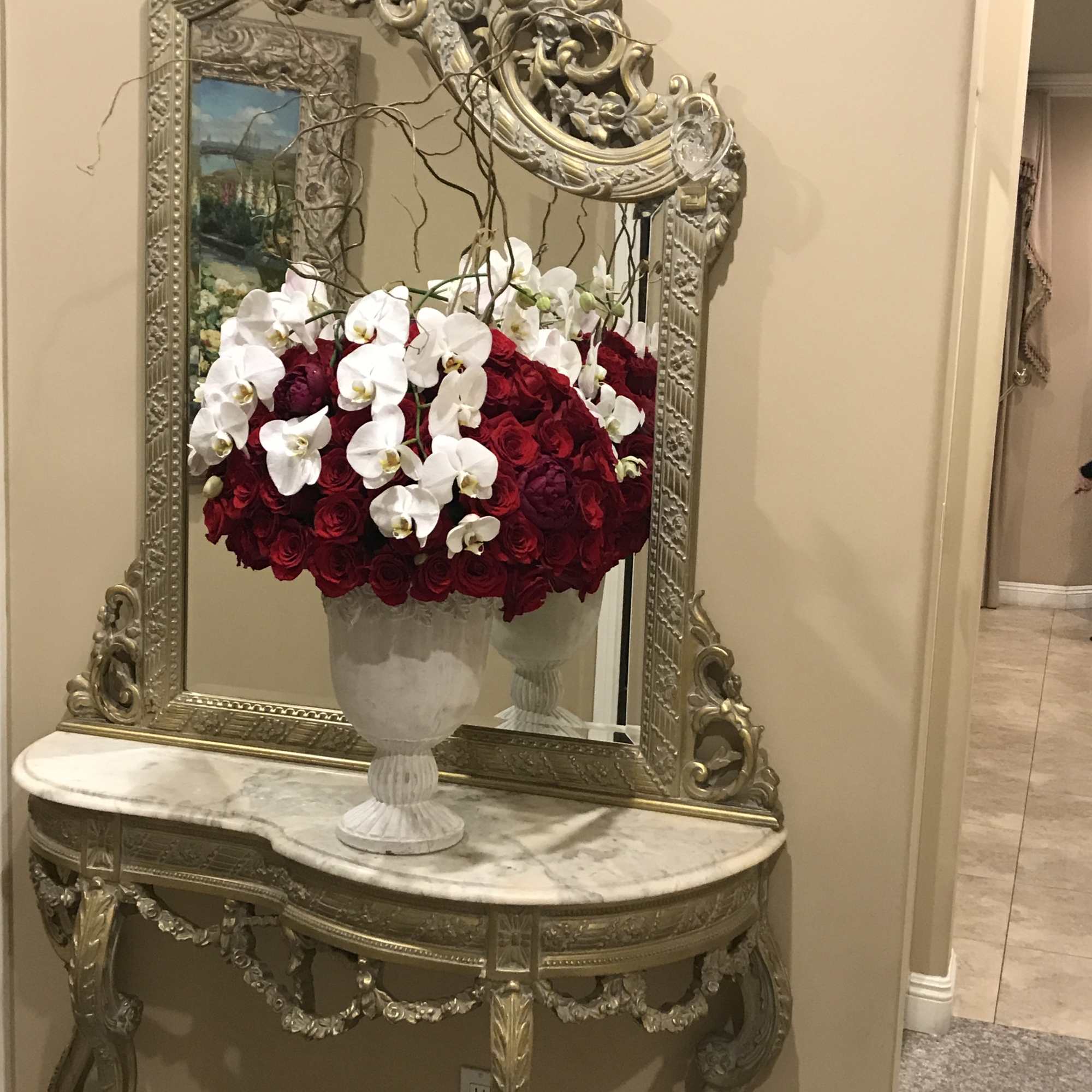 Romantic and extravagant red roses and white orchids arranged in a unique