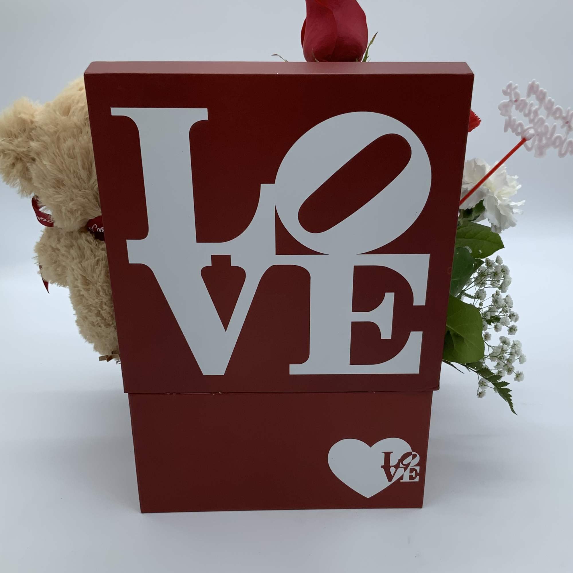 Red gift box with a rose, teddy bear, and white flowers