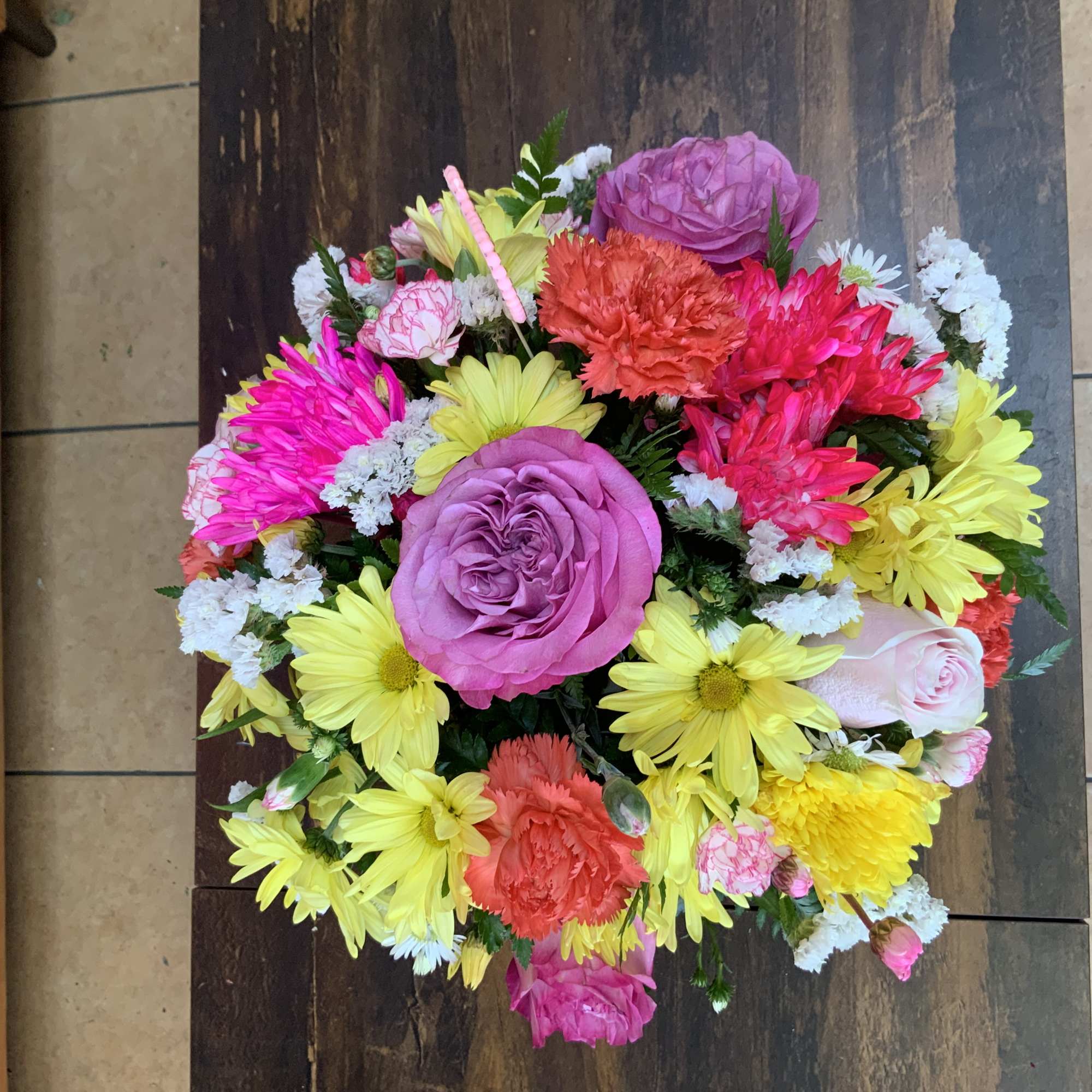 Dazzling metallic cylinder container with lilies, hydrangeas, roses, and other beautiful flowers.