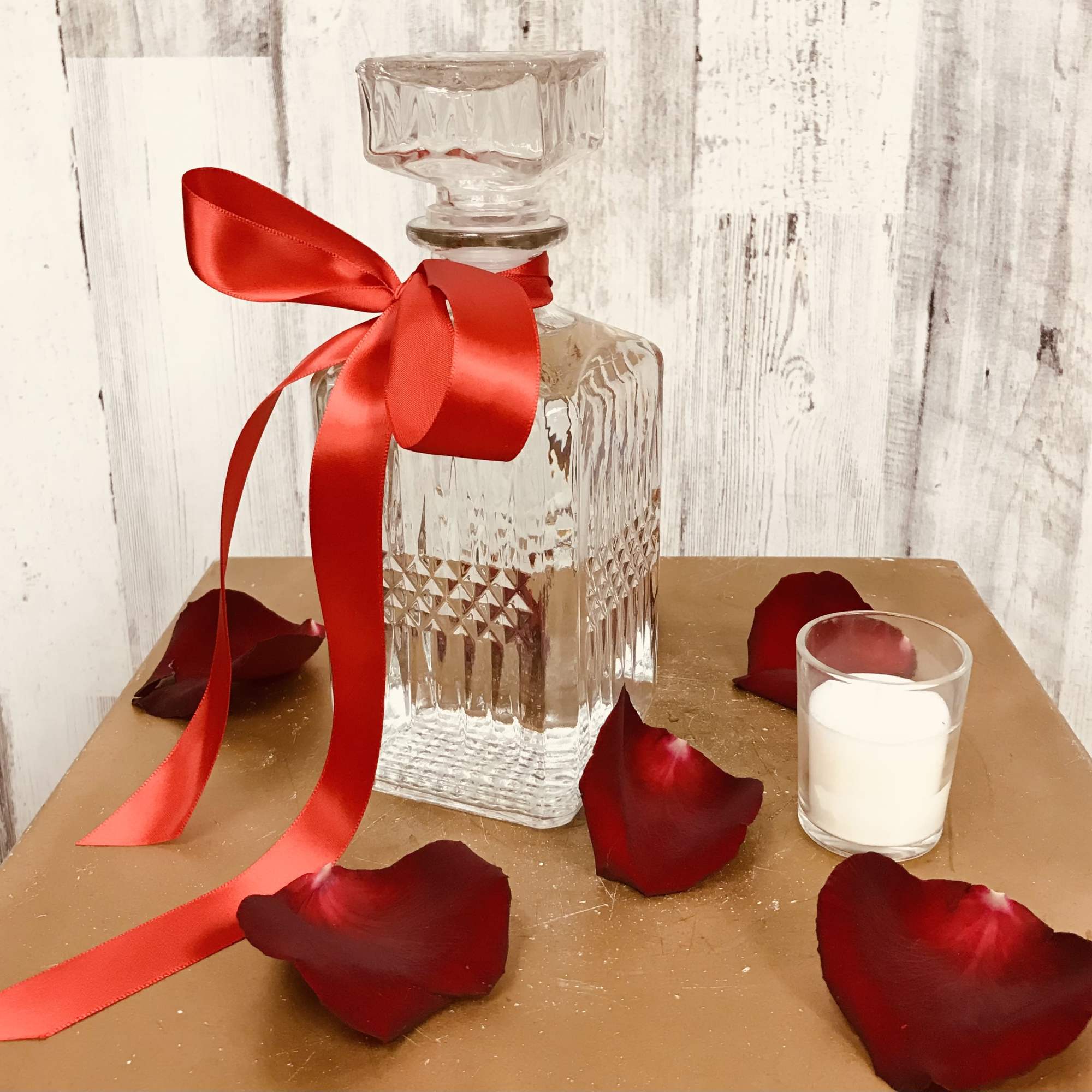 Long stem red roses surrounded by beautiful filler, arranged in a keepsake