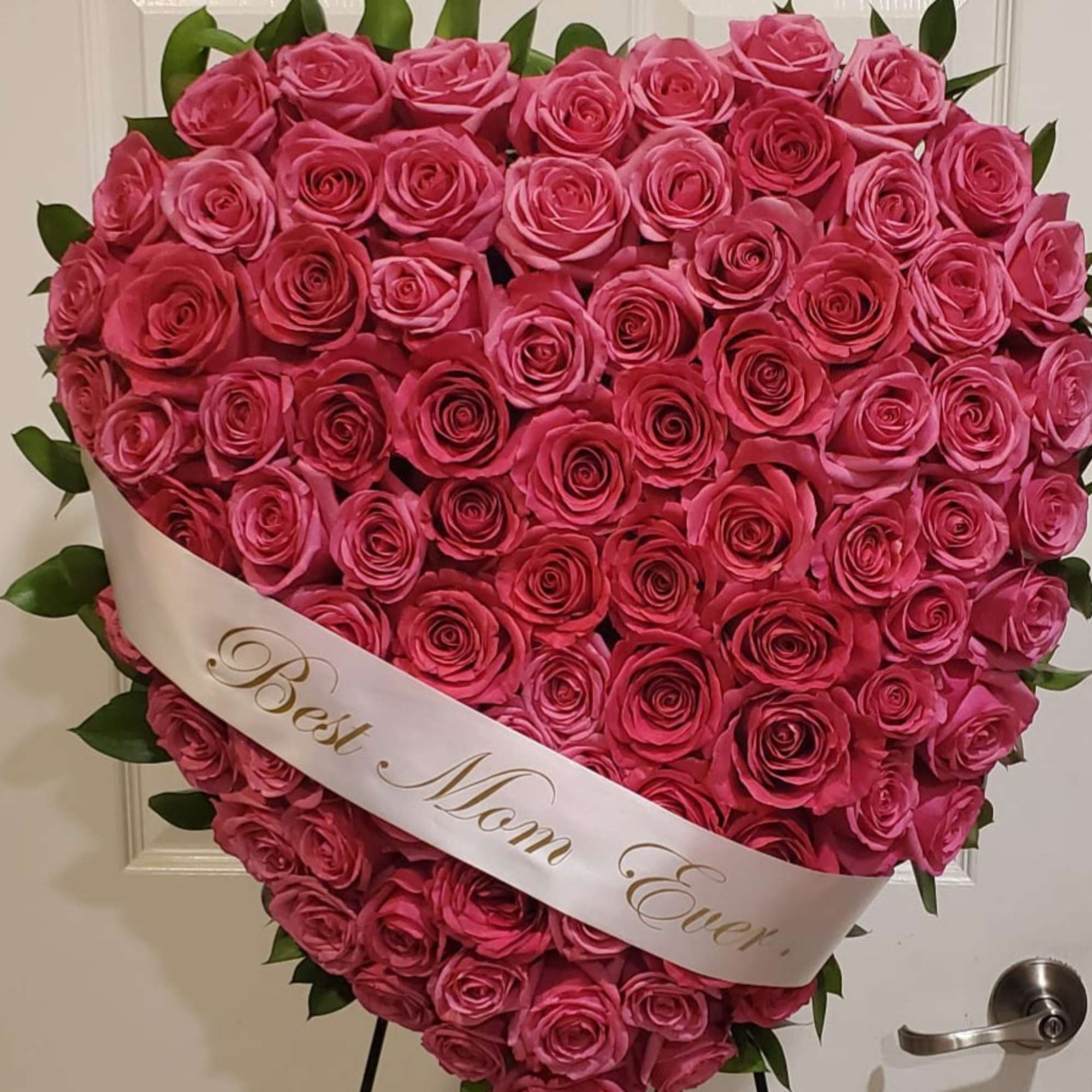Heart-shaped bouquet of pink roses with a "Best Mom Ever" sash
