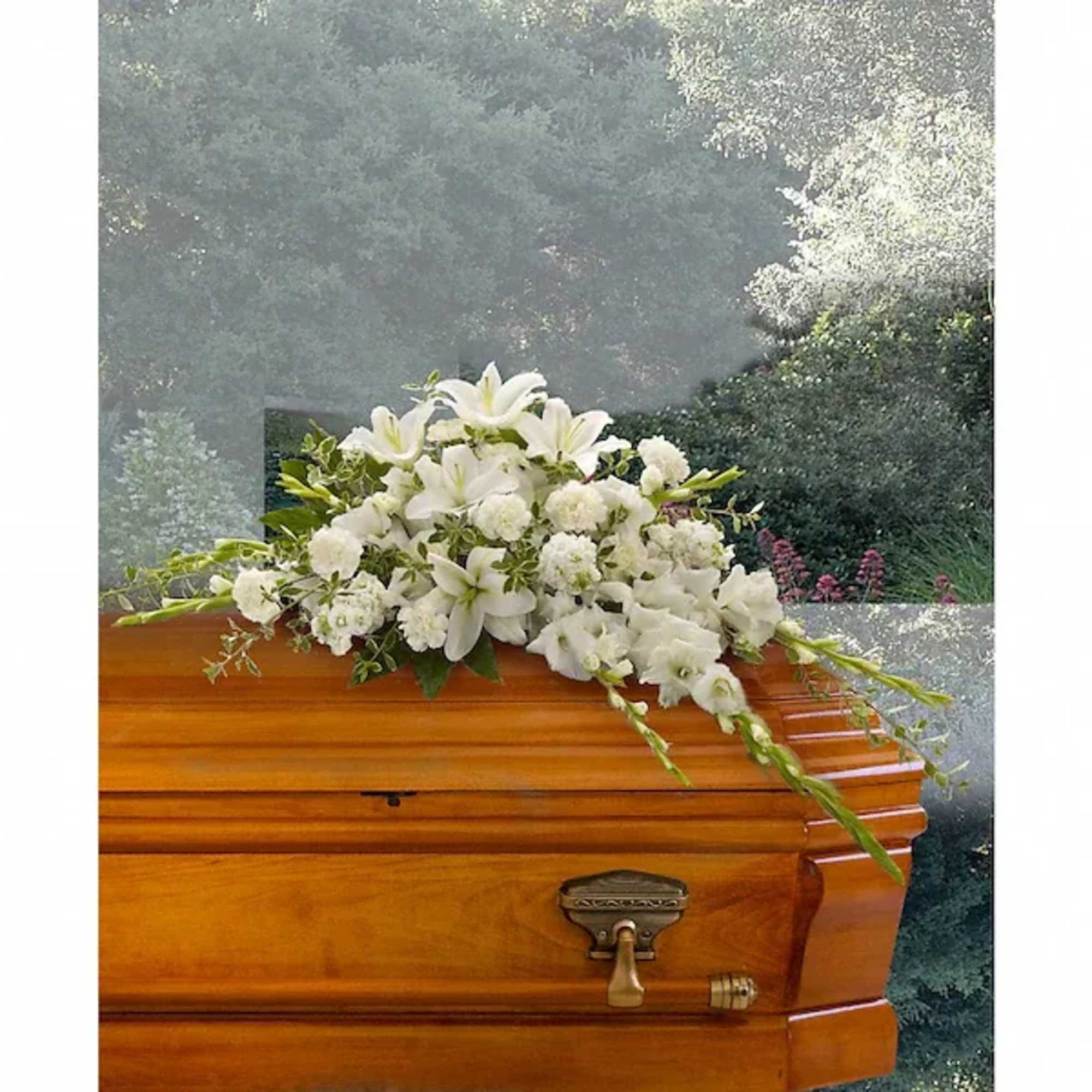 White floral spray on a wooden casket