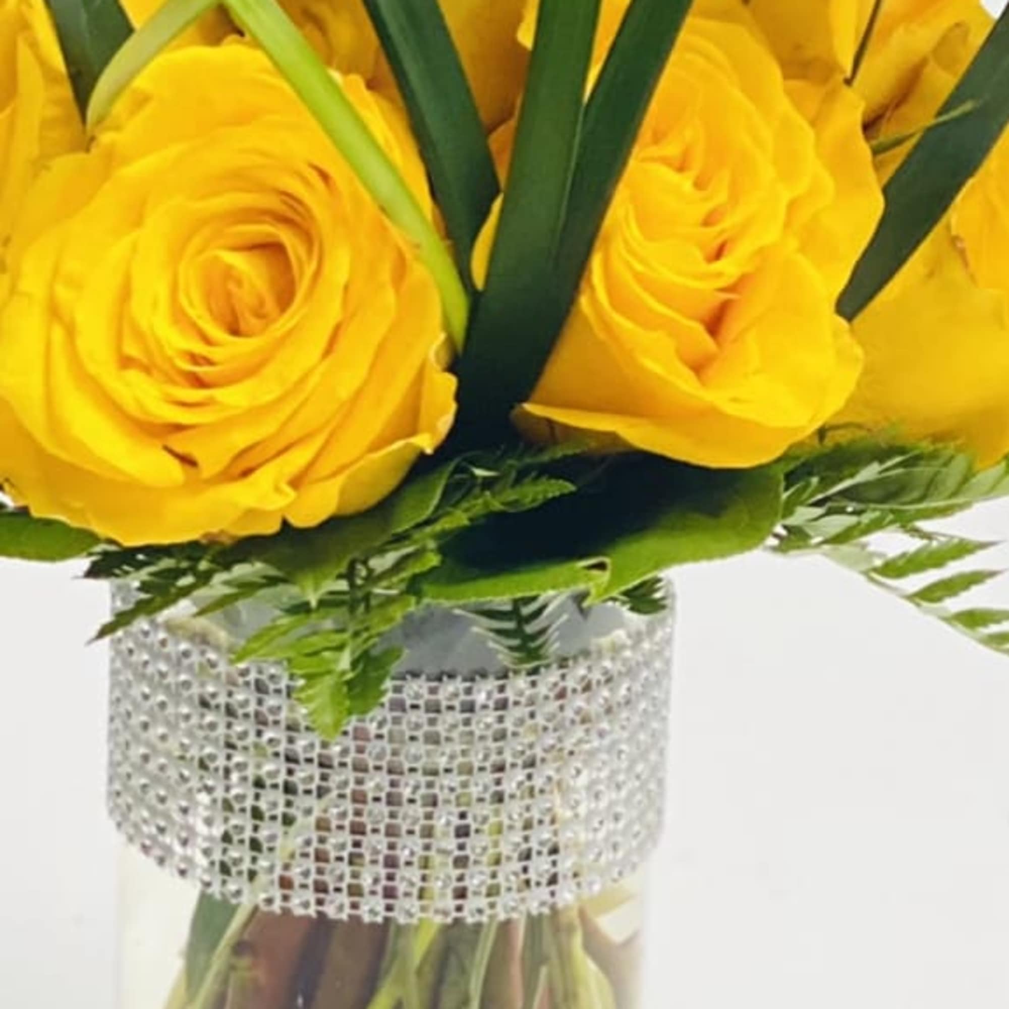 12 yellow roses encased in Lilly Grass with a Diamond wrapped vase