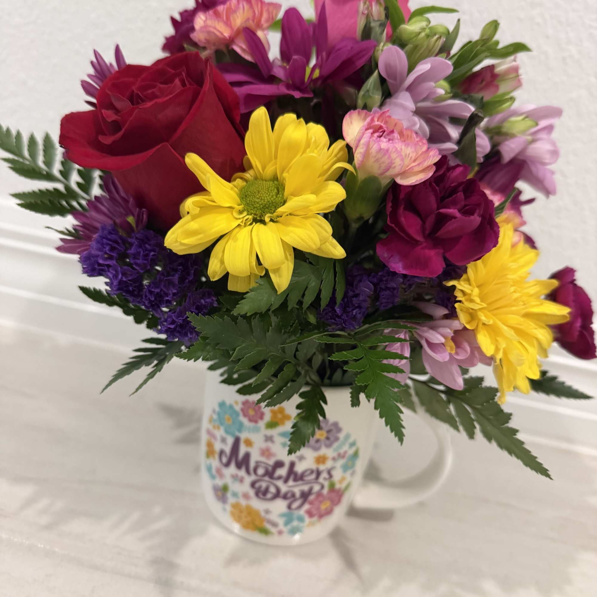 A beautiful &ldquo;Happy Mother&rsquo;s Day&rdquo; mug with fresh flowers&mdash;perfect to brighten her