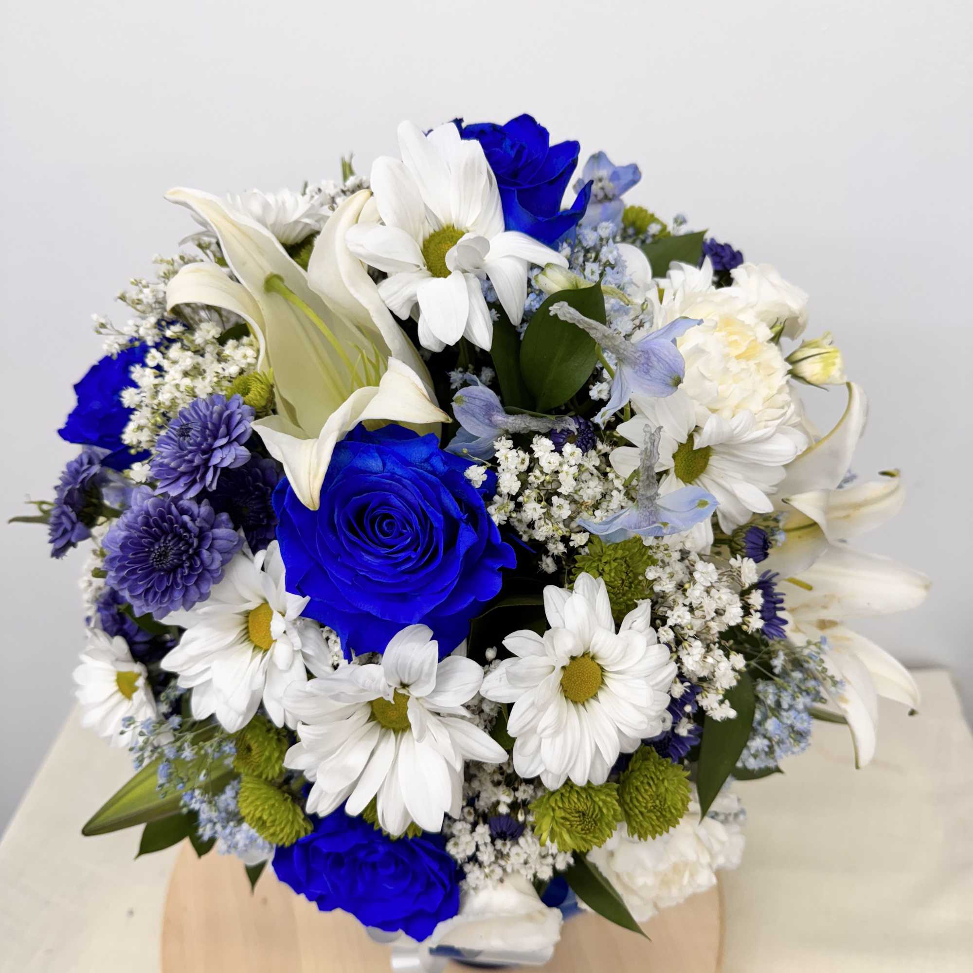 Bouquet of blue roses, white lilies, and white daisies