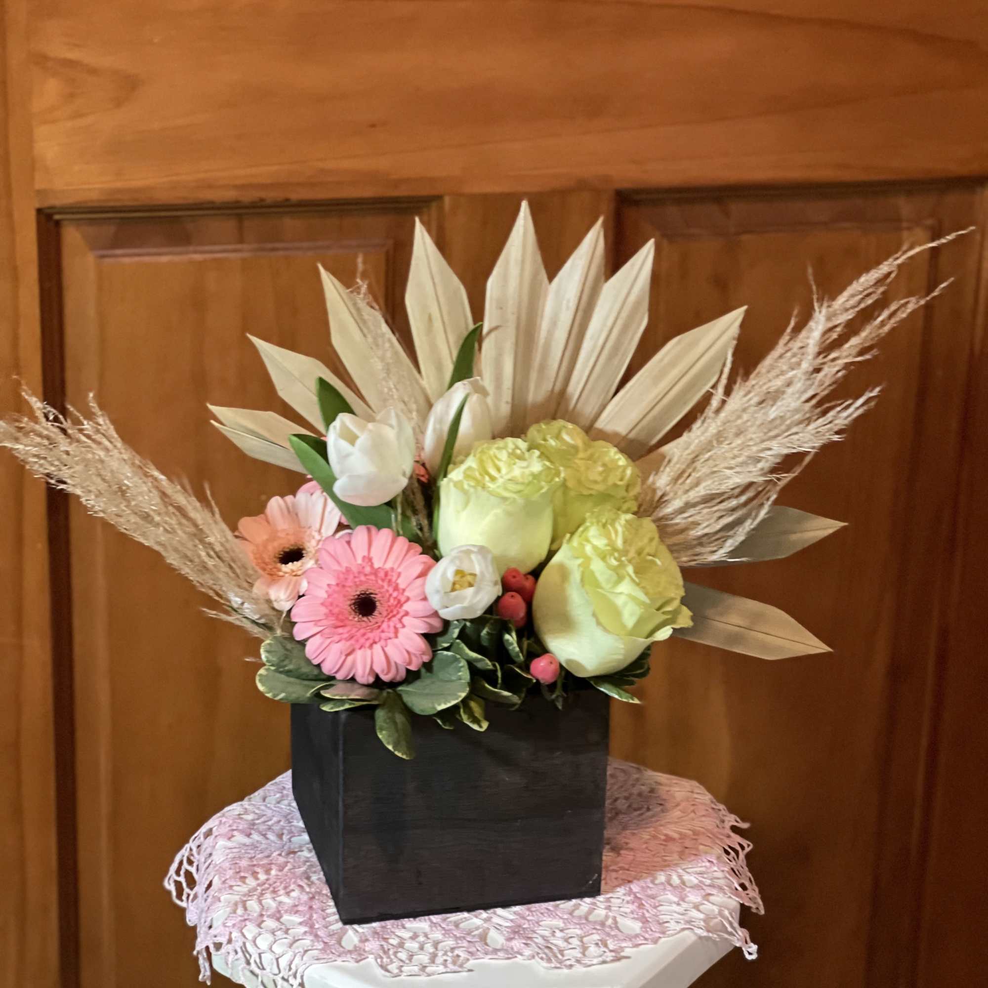 Mixed bouquet with pink and green flowers in a black square vase