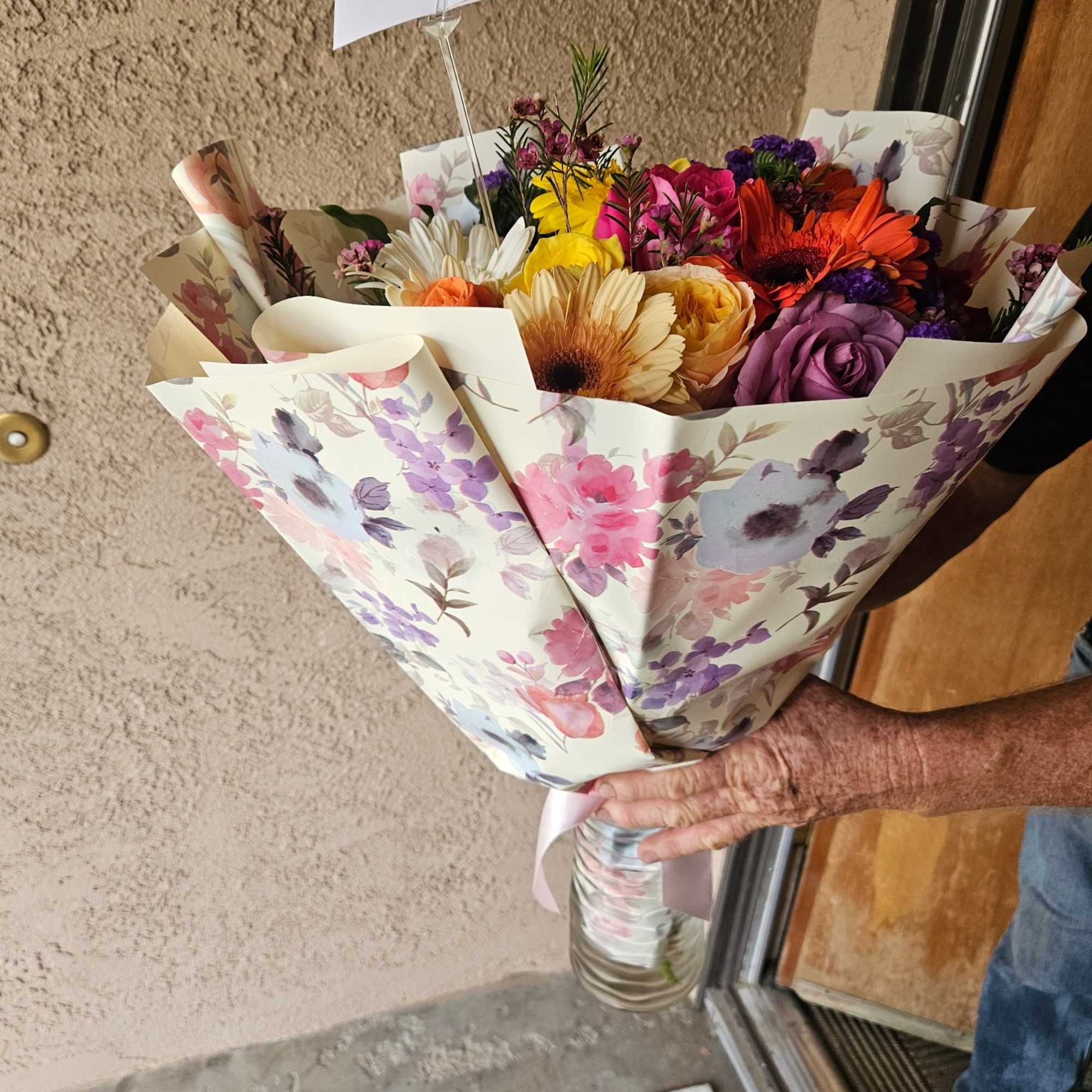 Paper wrapped hand bouquet with no vase will be provided with wet