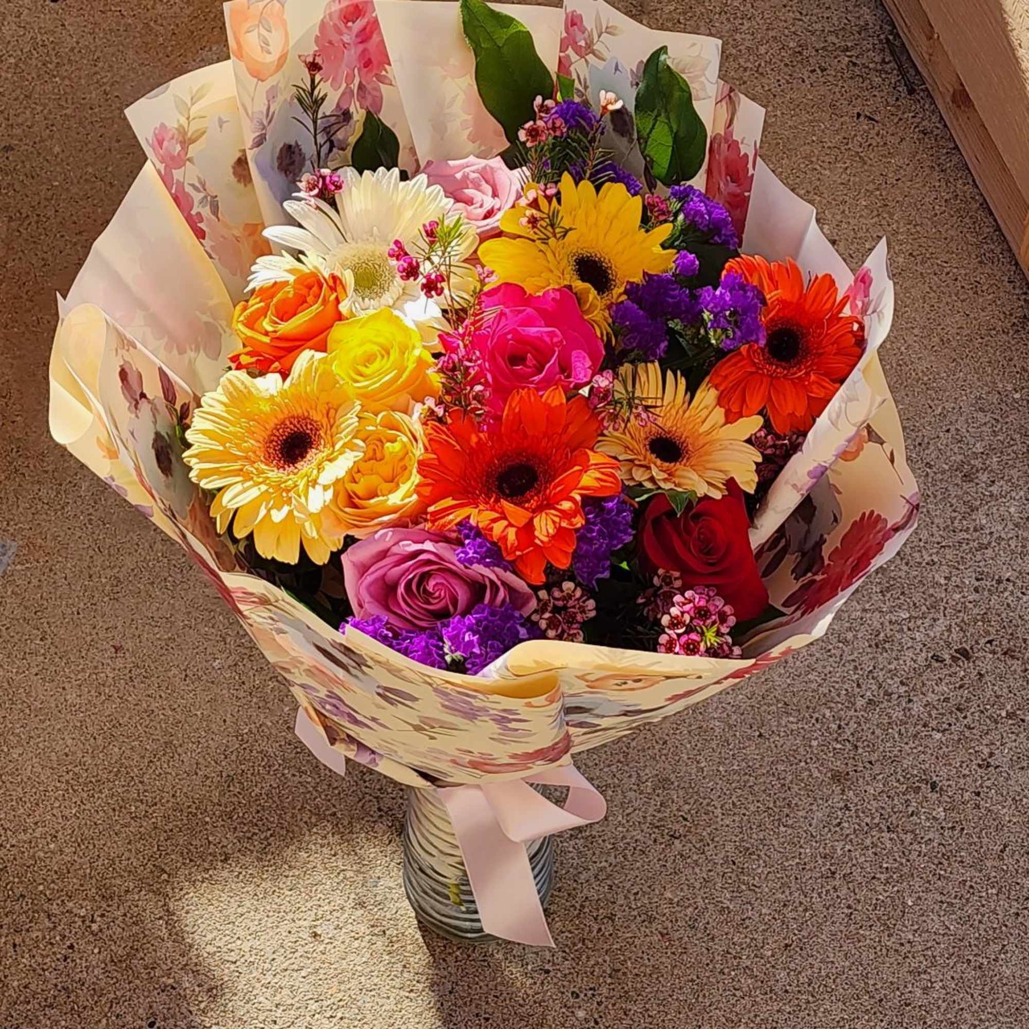 Paper wrapped hand bouquet with no vase will be provided with wet